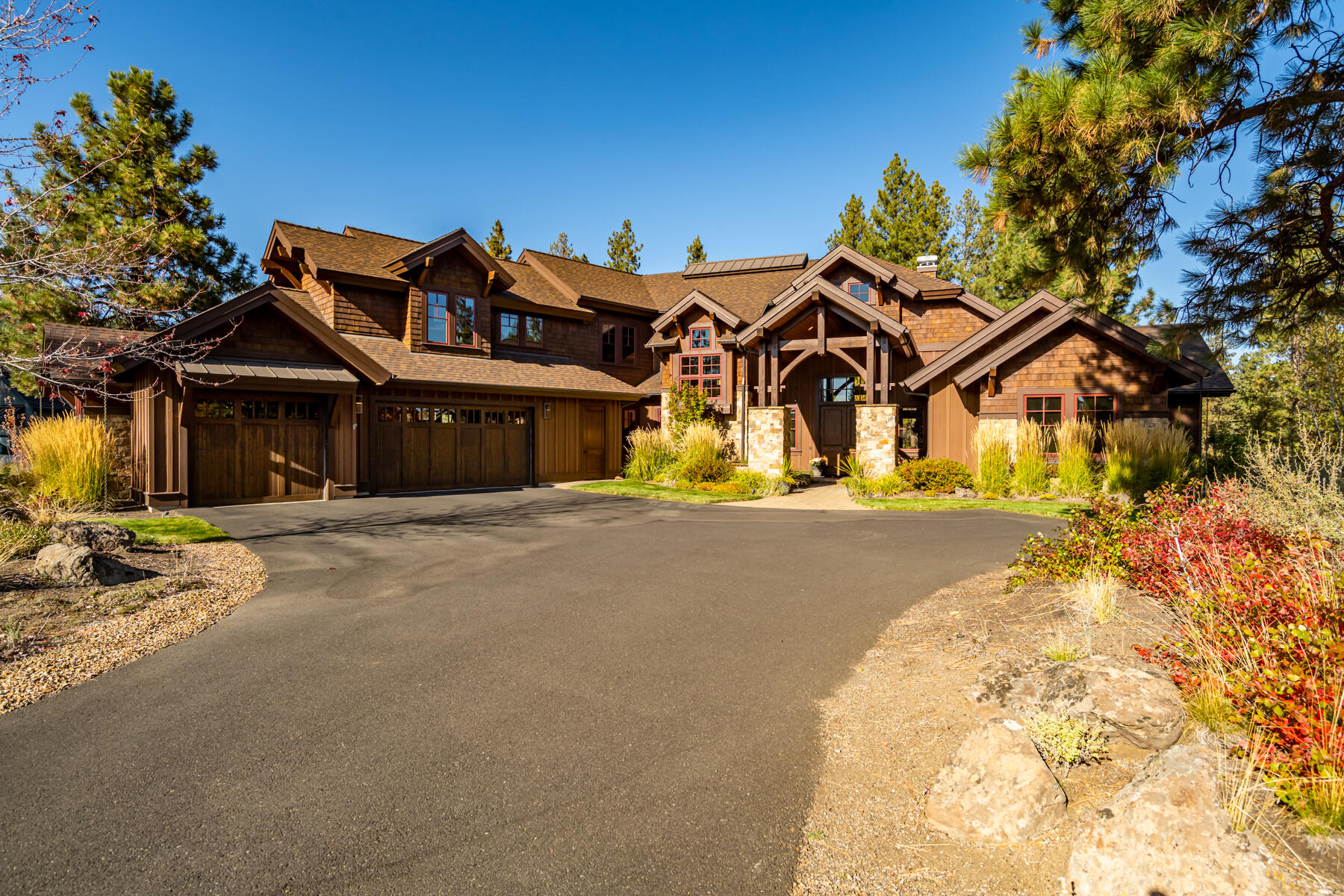 Quality abounds in this beautiful Northwest custom home in the premier Tetherow resort community. Offering a wonderful, quiet backdrop overlooking the 7th fairway of Broken Top Golf Course. Welcoming front entry with stone and wood details and a cascading water feature. Spectacular great room highlighted by gorgeous bamboo hardwood floors, vaulted wood beamed ceiling, and an impressive floor-to-ceiling Montana Moss stone fireplace. The chef's kitchen is the heart of the home, featuring an Italian Bertazzoni 6-burner gas stove with dual ovens, slab granite counters with chiseled edge, and large island with breakfast bar. Both primary and guest suites are located on the main level. Two additional bedroom suites plus a spacious bonus room are located upstairs. Interior updated with new paint throughout every room. Conveniently close to downtown, schools, retail, microbreweries, river trails, golf, and Mt. Bachelor ski resort.