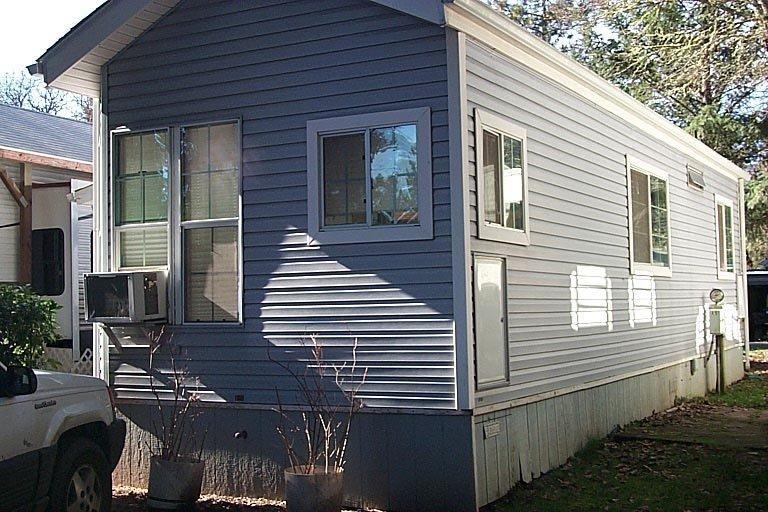 Park model single wide in RV Park. The park is on the Illinois River - a spot to enjoy swimming, paddle boat and more. The location of this Park Model is in the 55+ area of the park. 12 x 33 Cavco with 396 sq. ft. 1 Bedroom / 1 bath - lots of windows, storage everywhere. Could use some TLC but could be a nice place for 1 or 2 folks. Storage shed provided by park and current rent of $295.00 includes water, sewer and trash. This unit could be moved onto your property or to another location.