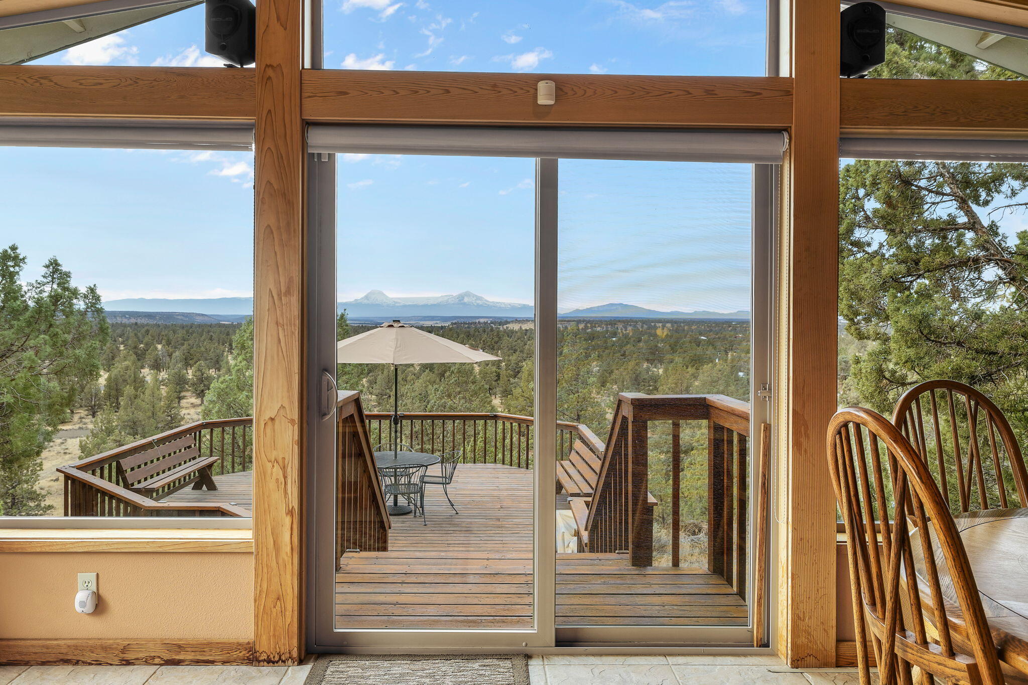 Welcome to your dream home, where breathtaking views of 11 majestic Cascade mountains set the stage for an unparalleled living experience. This stunning property has 3 bedrooms, 2 baths, and a versatile flex room that can be an extra bedroom. The kitchen offers natural light by the skylight, tile floors, a nice pantry & a cozy nook for casual dining. The Sunroom addition just off the living room, features wrap-around floor-to-ceiling windows that frame the amazing views. Picture lively dinners at the dining room table, and an evening watching the sunsets - all while being surrounded by the great outdoors. 2 outdoor decks for soaking in the panoramic vistas. 1 deck is fully covered to enjoy the scenery regardless of the weather. The paved driveway to the 2- car garage is a bonus. 2 outbuildings with room for extra parking and a dedicated workbench are equipped with 220 power & 30 ampRV service. Featuring sliding barn doors & 2 stalls that open to a fenced area. Only 5 min to Terrebonne