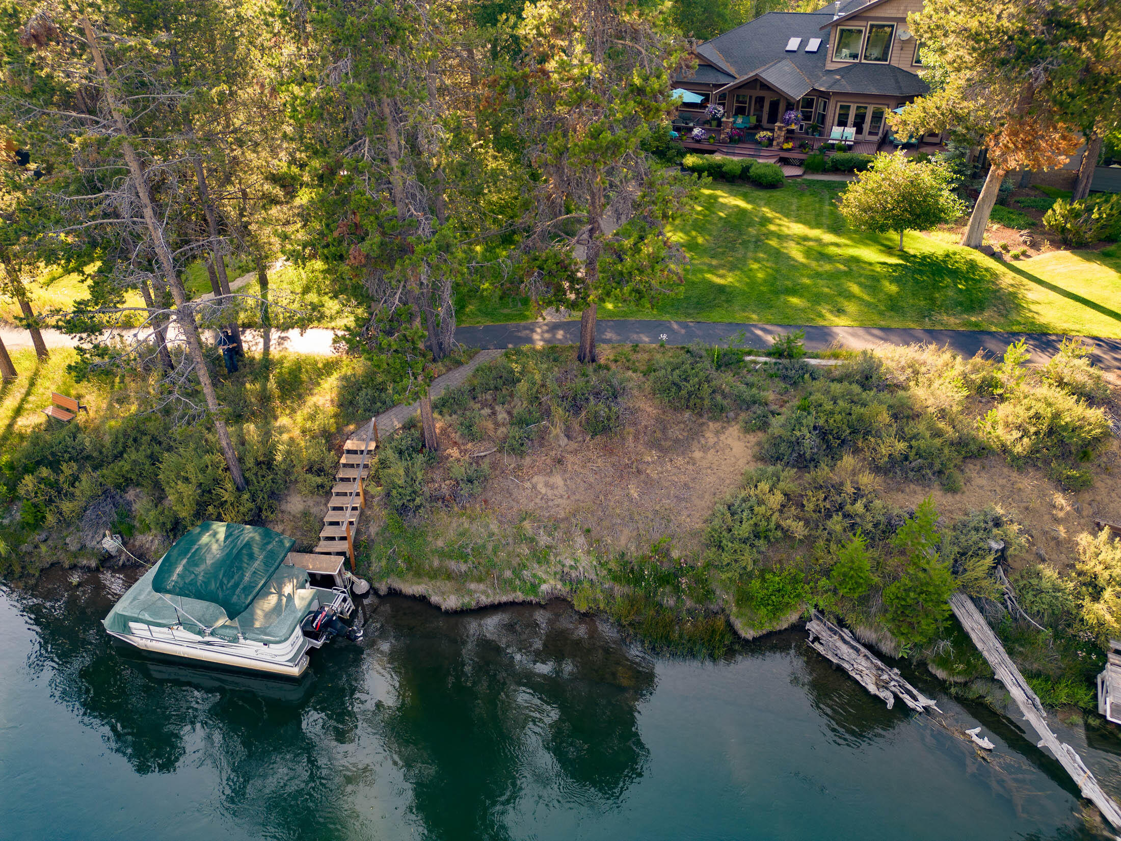 Welcome to paradise along the magnificent Deschutes River! This exceptional riverfront masterpiece is an embodiment of luxury living and a rare opportunity to embrace the unparalleled beauty of Central Oregon. Step inside and be captivated by the exquisite craftsmanship and thoughtful details that define every room. A Great room concept, with chef's kitchen and 3 en-suite bedrooms. The primary suite includes dual walk-in closets & 2 private full baths, w/soaking tub and stone showers. The 2nd floor is perfect for generational living with views of Mt. Bachelor & the Deschutes River. Fully furnished, complete with gym, wood shop, koi pond, elevator, 3 car garage, Pontoon Boat (!!), and so much more; you are ensured for a seamless transition into luxury living. Don't miss this unparalleled opportunity to claim the Deschutes River as your own. Discover the extraordinary lifestyle that awaits, where every detail is designed to exceed your expectations of comfort, style, and natural beauty