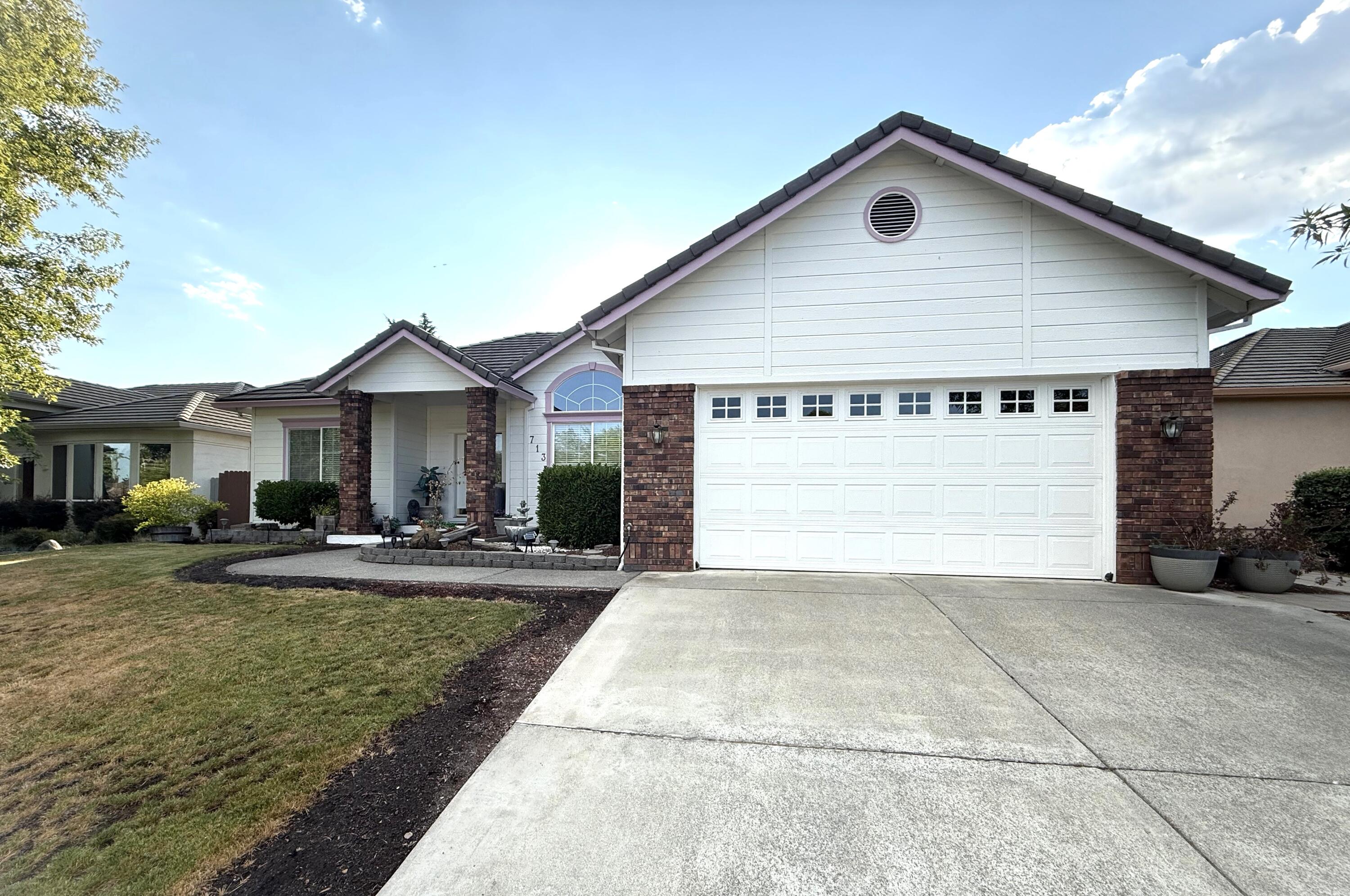 Discover comfort in this spacious 3-bed, 2-bath home with 1,903 sq ft of well-designed living. Built in 2000, it features a Great Room floor plan with soaring ceilings and hardwood floors in the open kitchen with eating bar and cozy breakfast nook.  There is also a separate front living area that offers flexible space for a playroom, office, or quiet retreat A split layout offers privacy, with a luxurious primary suite including a walk-in closet, soaking tub, and walk-in shower and a sliding glass door to the covered patio off of the Primary Suite.  Enjoy indoor-outdoor living with the other covered patio off the nook/great room area as you look out onto the large backyard ideal for relaxing or entertaining. Topped with a durable tile roof and perfectly located near shopping, dining, and a fitness center, this home offers the ideal blend of style, space, and convenience.