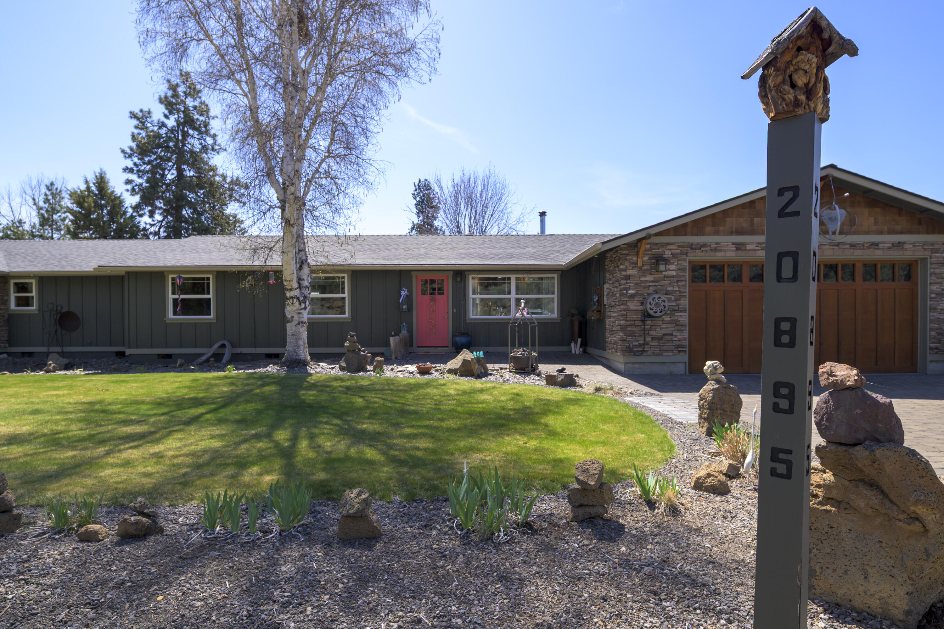 Built in 1977 and thoughtfully updated over the years, this well-maintained single-level home sits on a spacious 0.56-acre lot in desirable SE Bend. Offering 2,568 square feet of comfortable living, the home features 3 bedrooms, 2 bathrooms, and an open floor plan that's perfect for everyday living and entertaining alike. Inside, enjoy two fireplaces, a recently expanded kitchen, and plenty of natural light throughout. Recent improvements include a newer roof, fresh exterior paint, and a new hot tub—ideal for soaking under the stars. The property truly shines with a nearly 2,000 sq ft 3-bay shop, fully wired with 220 power—perfect for hobbyists, craftsmen, or RV storage. A brand-new asphalt driveway leads to the shop, with ample room for RVs, boats, or additional vehicles. Also includes a greenhouse, mature landscaping, and a private setting that's just minutes from local shopping, schools, and outdoor recreation. This SE Bend gem offers a rare combination of space, convenience and