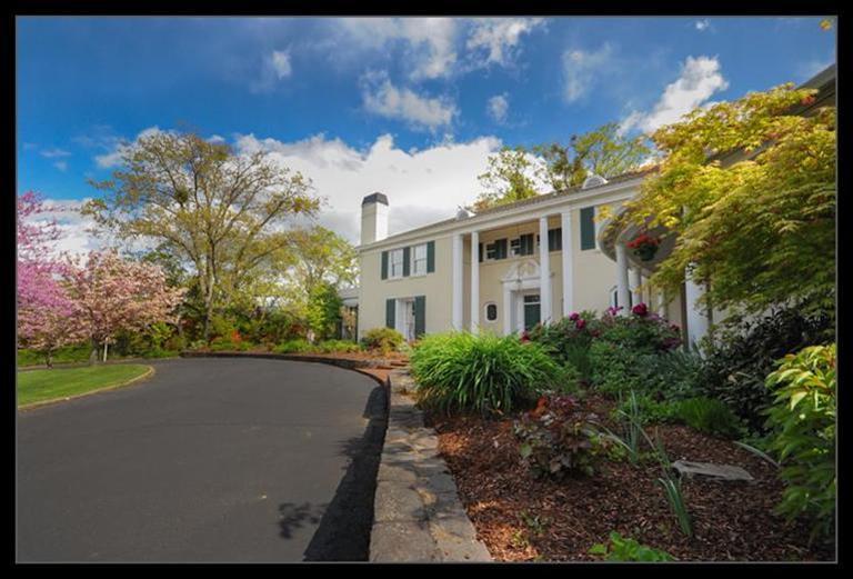 One-of-a-kind 1939 estate in Old East Medford is the original home of Harry Holmes, founder of Harry & David. The grounds and the 5,500 sq ft house were designed by celebrated architect Paul R. Williams, and are in impeccable condition. Current owners have renovated the house to maintain the historic look and feel while including modern features. The original overgrown grounds have been transformed into an oasis of plants blooming 9 months a year under magnificent native oaks, and include one of the Rogue Valley's first in-ground pools, a pergola, and a shaded flagstone patio. The 1.6-acre gated parcel is one of the largest residential lots in Old East Medford and is in turn surrounded by 19-acre Holmes Park. The grounds can accommodate 30+ vehicles. There is a separate studio for guests or caretaker. Views extend to Mount Ashland and the Siskiyou Mountains. This is a unique opportunity to acquire a historic and exceptional property in the heart of Southern Oregon.