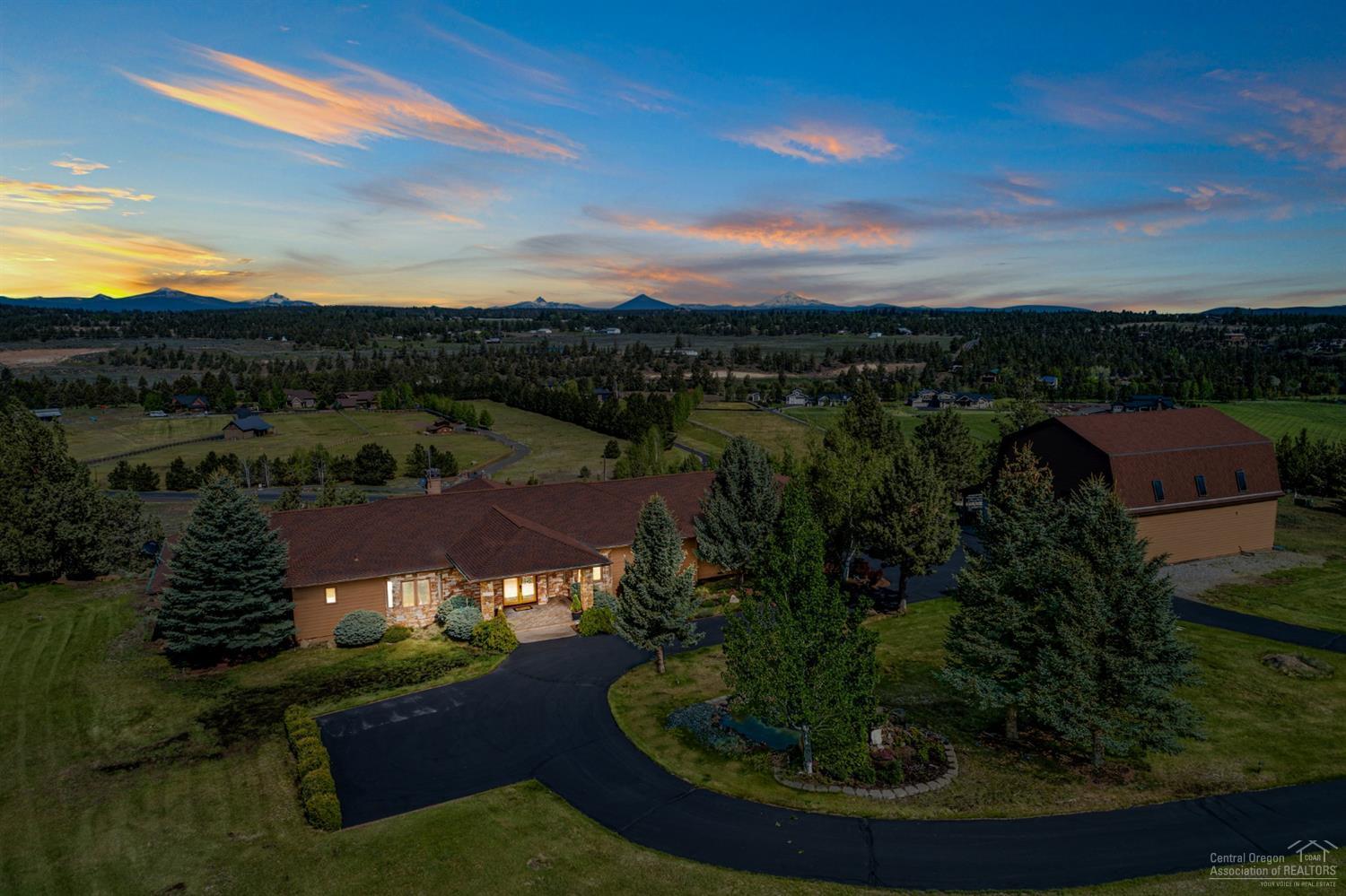 Gorgeous, single level home, is nestled in the middle of a 5.13 acre lot with 1.5 acres of irrigation. This home offers expansive mountain and pastoral views from every room. With 4 bedrooms, 4 full bathrooms, this 4253 sqft home has gorgeous beamed ceilings, a wall of windows for viewing the mountains, meticulously maintained grounds, all new SS appliances, new carpet throughout, and automatic blinds. This home has a huge kitchen, formal dining room, 2 marble fireplaces, marble shower and tub, along with new exterior/interior paint. This property has so much to offer with a three car garage, 34x44' (1575 sqft) shop that is complete with a loft, full bathroom, studio/bonus room, and an oil changing pit. This lovely Winston Ranch property in Tumalo will not last!