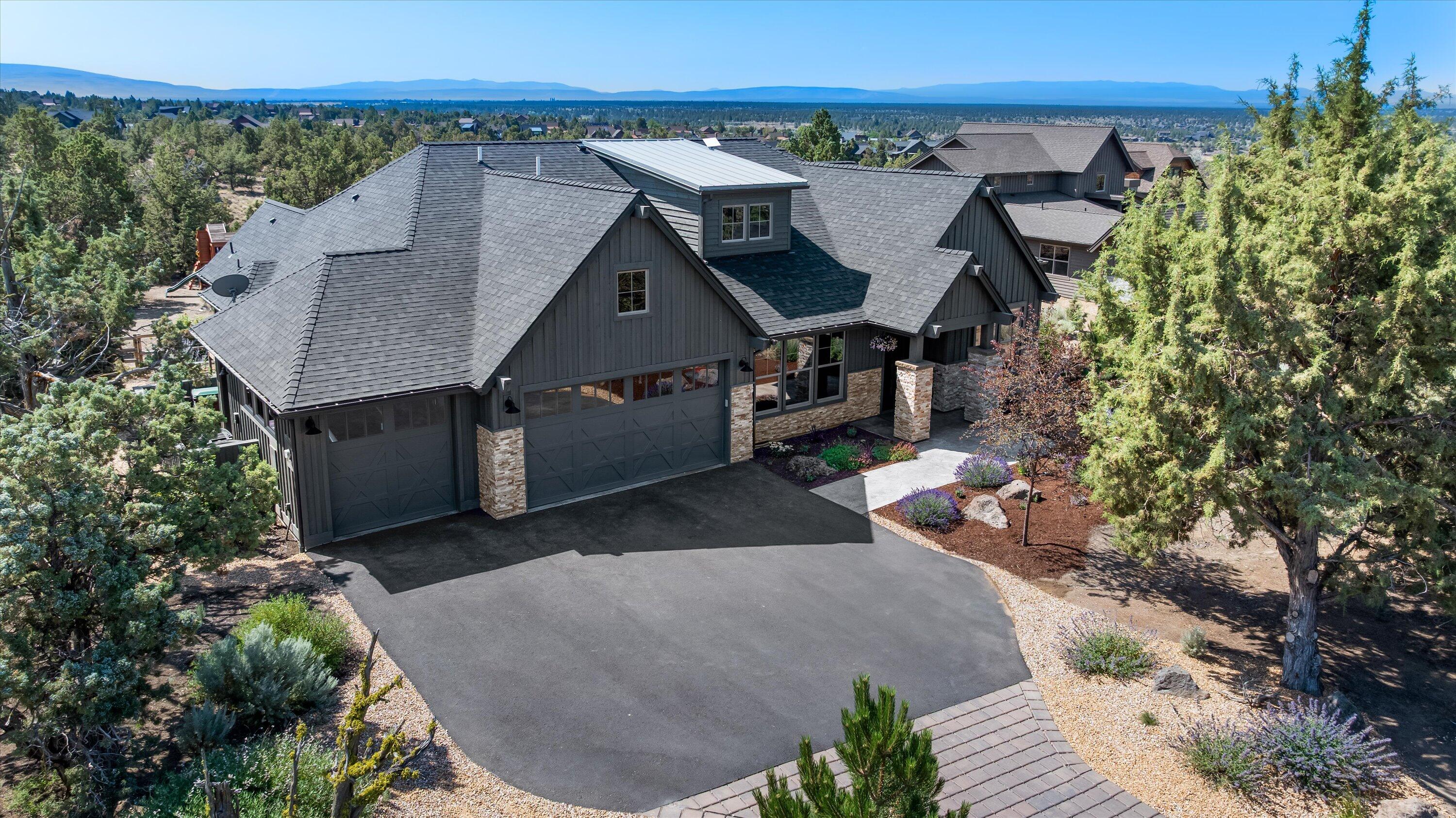 Warm and charming ranch style home accentuated with a large amount of stone and stained cedar siding on the exterior. Partial Cascade Mountain views are visible from the interior and exterior covered patio. 

This home has a very natural flow as you enter the foyer and are greeted on either side by the den and the dining room. The great room, kitchen and dining nook area are wonderful for entertaining. The kitchen features stainless steel appliances, a walk-in pantry and a large slab island and countertops. The primary suite has French doors leading to a private exterior patio and the primary bathroom has a gorgeous stand-alone tub. Beautiful hardwood flooring throughout the majority of the main living space and a raised hearth fireplace with stone are lovely features. A third bay garage allows for recreational toys, a small working area for a shop or another vehicle. Additionally, there is room for an ancillary structure to be constructed on the property.