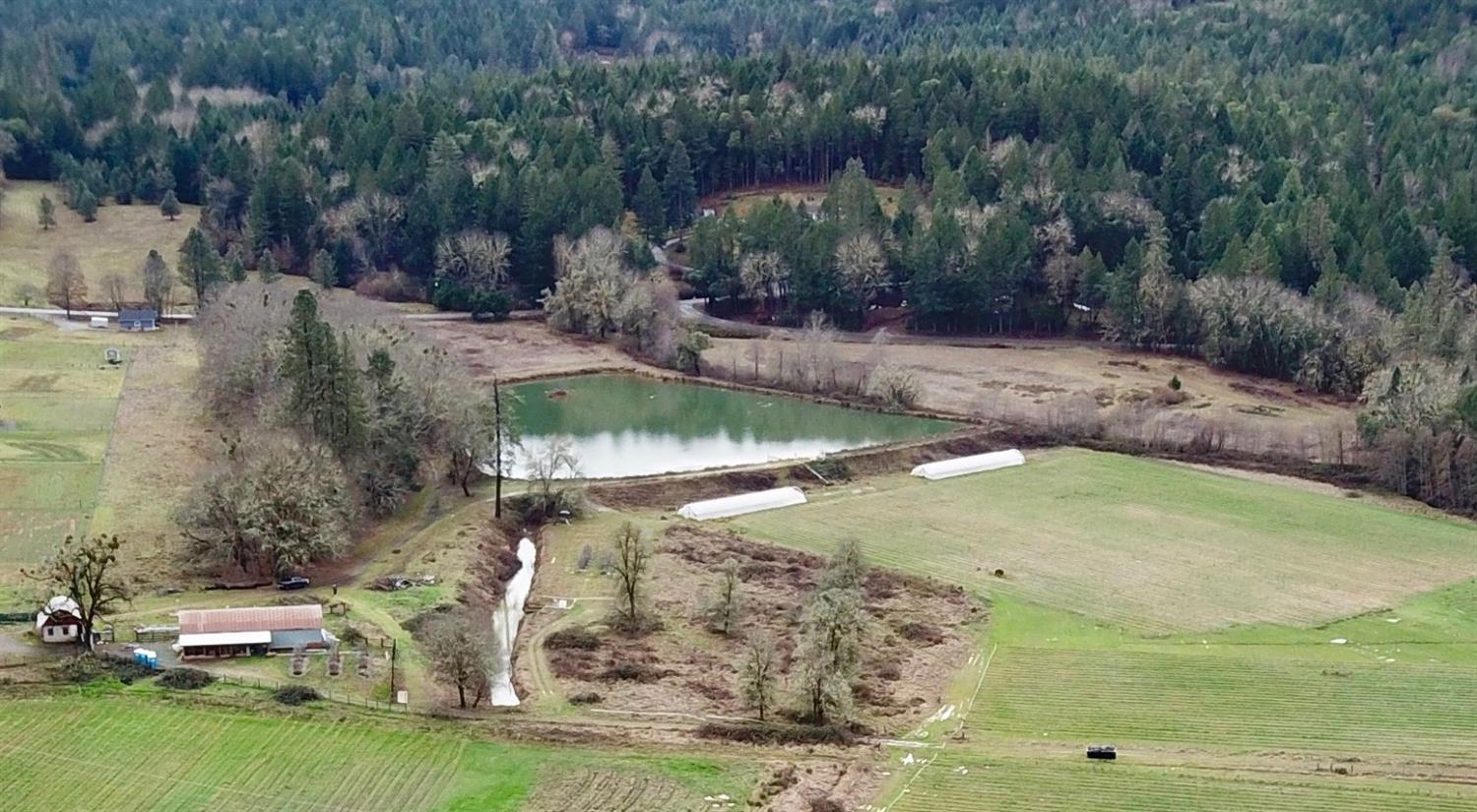 23.96 acres zoned Farm Resource, Irrigation Rights dated 1922 from Madams Creek, 4.5 acre Reservoir, Farm House & Multiple Outbuildings to Offer. Potential for future agricultural farming, livestock grazing, vineyard or your future dream home. Early 1900's farmhouse updated in 2016. Updates include, flooring, paint, appliances and multiple mini split HVAC systems. Domestic well to serve main home and a new 2nd well (60gpm per well log) for potential new homesite. Additional outbuildings include milk barn, hay barn w/new concrete floor & work shop, equipment shed and detached 2 car garage with carport. Located 11 miles from central Grants Pass & 2 mins from the famous Finley bend fishing hole across from Matson Park. Owner carry terms available to qualified buyer. All information deemed reliable, but not guaranteed. Anyone considering purchasing this property should perform their own investigation into the uses and condition of the property.
