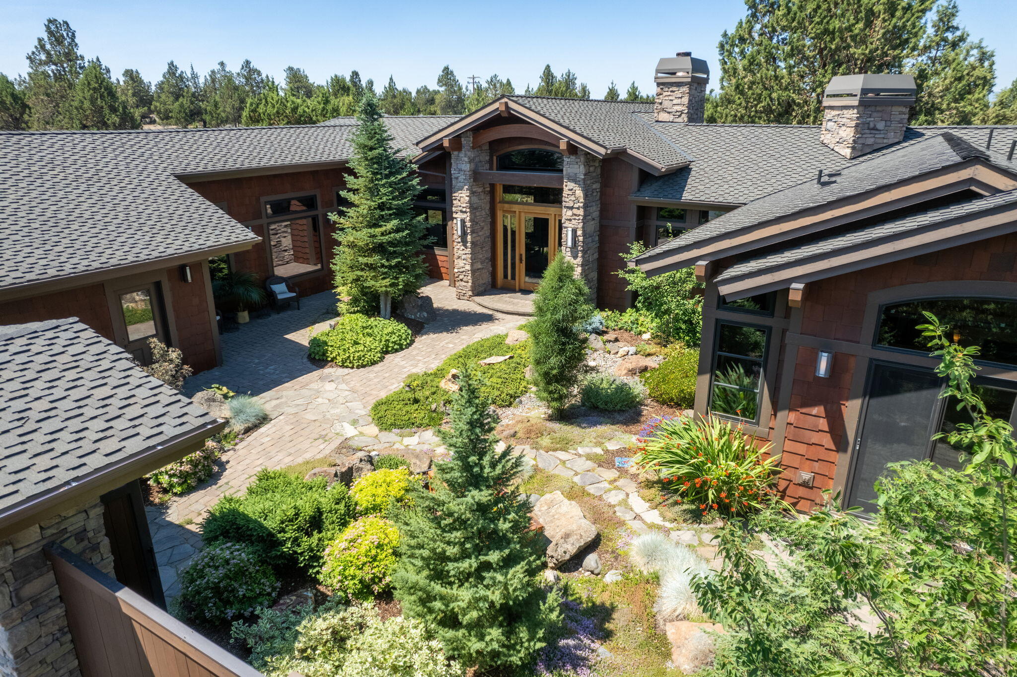 Discover unparalleled luxury in a Norman Building & Design custom home located in the serene Lane Knolls community on the quiet side of Bend. Nestled in an exclusive enclave of only 48 homes & surrounded by Approx. 235ac open space & 3 miles of trails, this exquisite residence offers tranquility & elegance. Situated on 3.12ac this home provides ample privacy & space to enjoy the natural surroundings. This private oasis featuring a gated sensory courtyard w/ a built-in outdoor fireplace. This home boasts intricate woodworking details throughout, enhancing its sophisticated charm. The primary suite is a sanctuary of relaxation, featuring a spa-like bathroom w/ a soaking tub, walk-in shower, double vanity, walk-in closet along w/ a spacious work out area. Embrace outdoor living w/ native plantings, 4 patios & views of the Cascade Mountains. Additionally, the home includes a 1,058SF garage, providing ample space for vehicles & storage. Experience luxury living in this Quality Built Home.