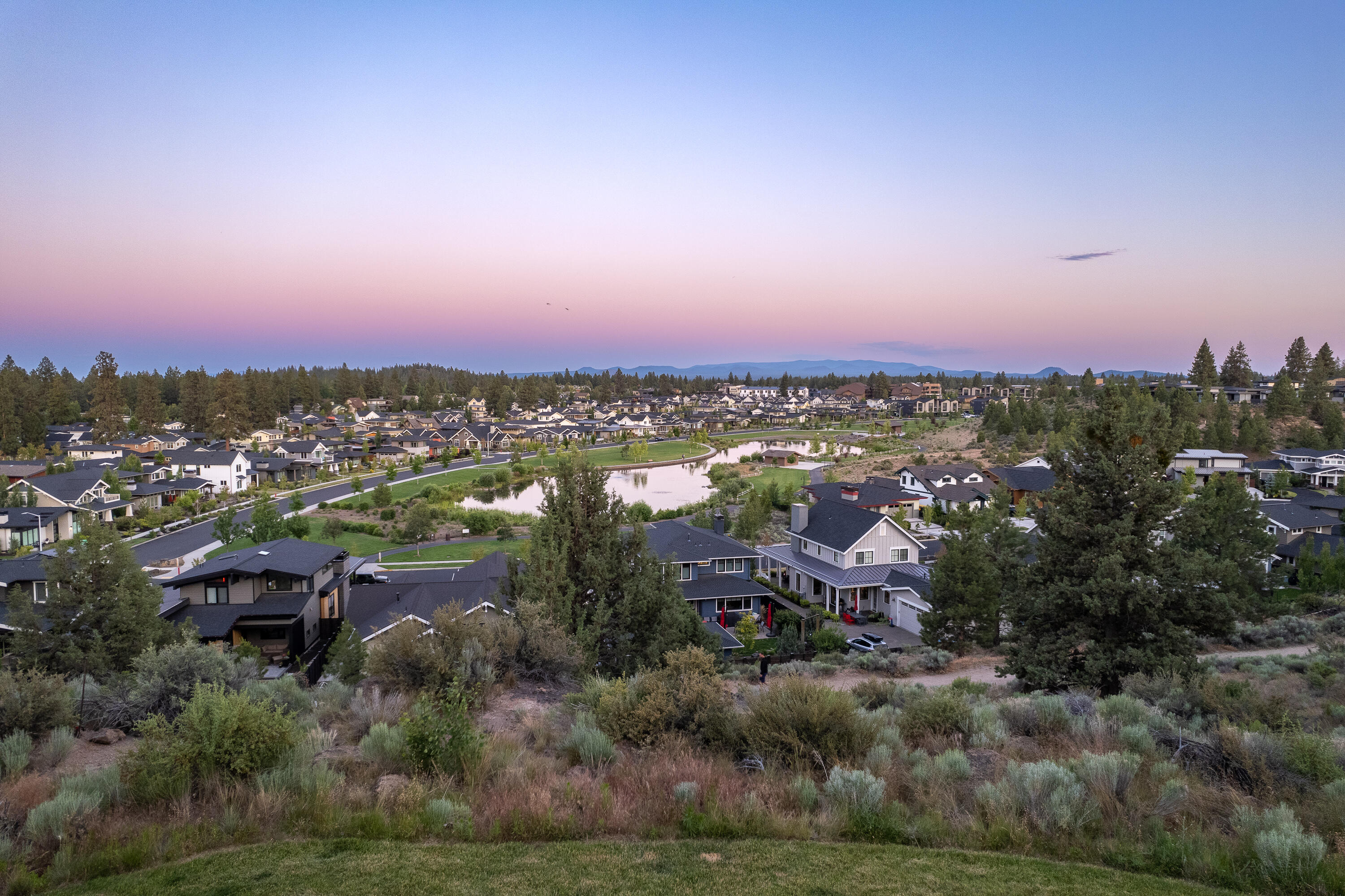 Welcome to this captivating 4-bed, 3.5-bath home nestled in the family-friendly Northwest Crossing neighborhood. With 3,262 square feet of living area, this home offers plenty of room for the whole family and more.  On the main level, find the primary suite tucked away in the back corner of the home for added privacy. With breathtaking views out the large back windows, you'll fall in love with this tranquil retreat the moment you step in. Further down the hallway you'll fine a designated office, laundry room/mudroom. The stunning kitchen featuring quartz countertops and top-of-the-line stainless steel appliances. Also on the main level, the second primary suite, with its own full bath and a kitchenette. Upstairs are 2 large bedrooms, a full bath, and a bonus room complete this level. Amazing outdoor living await as you step out onto the stunning patio that overlooks the rare .54 acre lot and vibrant neighborhood and park