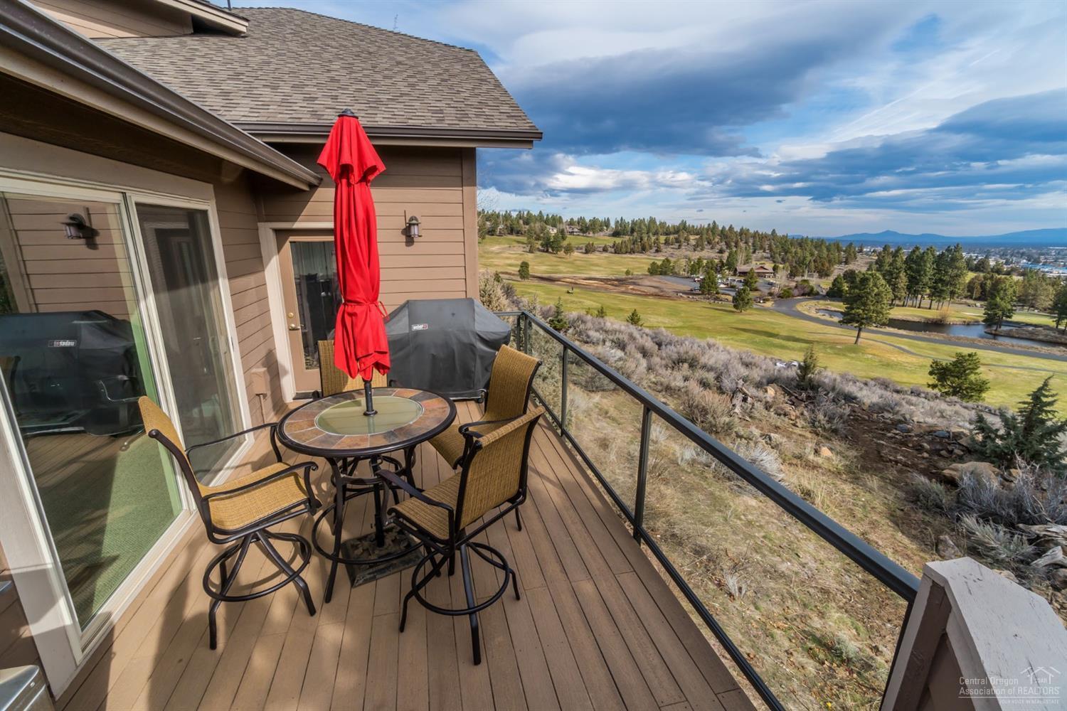Enjoy jaw-dropping views while living in this immaculate Northwest townhome. Master on the main, travertine tiles, real wood floors, new carpet, landscaping, interior and exterior paint. Contemporary living close to all that Bend has to offer. No HOA,oversized 2 car garage & flat driveway! Lot below is owned by sellers. They will offer first right of refusal to buyers of town home. Potential seller carry financing available on the RM lot depending on terms.Plans for remodel on existing townhome included.