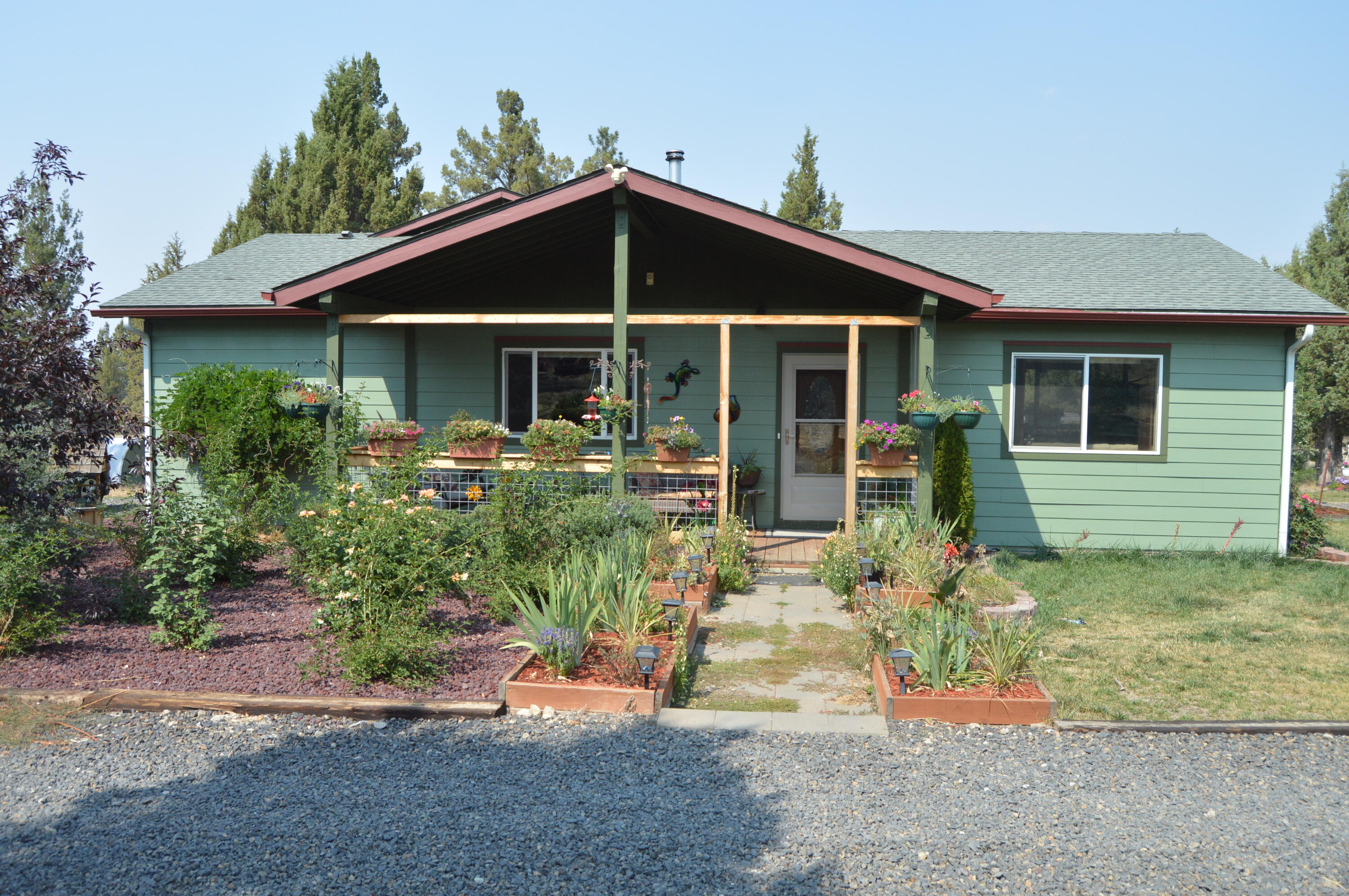 Wonderful rural property.  The maim floor of the house is 1519 sq ft with 2 bedrooms and 2 full baths.  A finished basement adds 396 sq ft and can be a 3rd bedroom.Bamboo floors except for the kitchen which is tile.  Apartment in the garage.  Finished 12x16 building for an office or whatever.  Property is not on the grid and operates on solar with diesel generator back up.  Grid power is available about 1/4 mile away.  Almost 4 acres is fenced and much of the rest of the property has posts in.  The front lot has 23.34 acres of R5 land and is being sold either with the home property for a total of 43.20 acres or separately for $35,000.00.  2 greenhouses, raised beds and plenty of other out buildings.