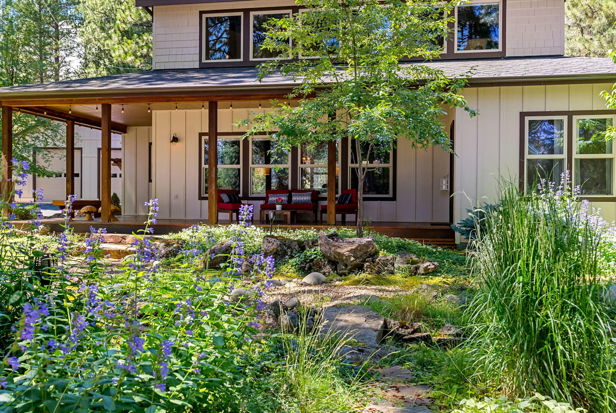 Welcome to your private retreat in the desirable River Forest Acres neighborhood where nature, comfort, & recreation come together. This beautifully updated home offers effortless enjoyment of the Deschutes River perfect for paddleboarding, kayaking, fishing, or peaceful walks along the water and forest trails. Just 23 miles to Mt. Bachelor, and 9 miles to the Sunriver Resort. Inside, the home is warm, inviting, and thoughtfully updated with charming details throughout. The main-level primary suite features its own fireplace and large picture windows that frame serene views of the garden and stream. Upstairs, a spacious loft, additional bedroom, and full bathroom provide flexible space for guests or a quiet home office. The outdoor setting is truly something special, a lush landscaped garden welcomes you with a meandering stream and tranquil pond. A standout feature is the finished detached shop and RV garage, adding an additional 1088 sq ft complete with its own outdoor seating.