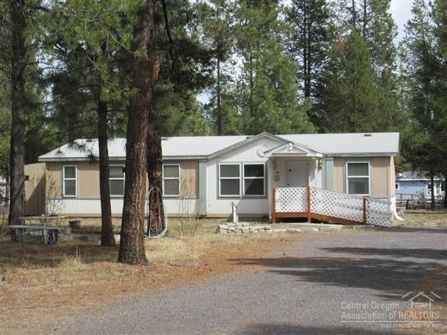 Property that has a lot to offer! This home sits back on the nicely treed property. Features kitchen with lots of counter and cabinet space, spacious master bedroom with french doors into the master bath. Plus garage and storage building for keeping items out of the weather. Circle driveway and RV Hookups. Close to paved road.