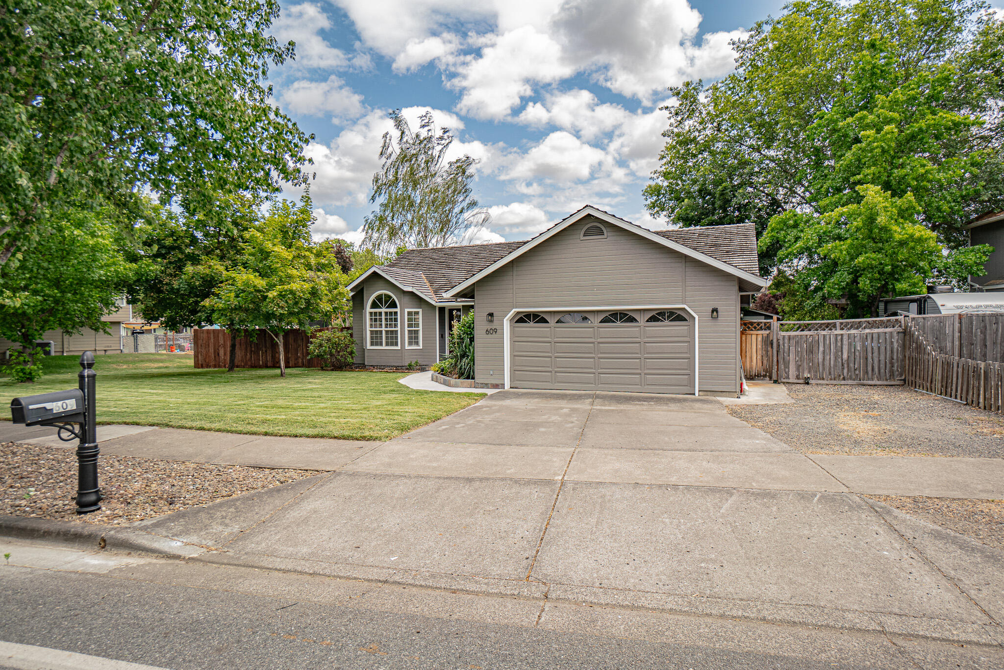 New carpet installed. This charming home is situated in a perfect location of Eagle Point's desirable tree lined streets. Within the past 5 years this well maintained home has been updated with exterior paint, tile plank flooring, water heater and heat pump HVAC system w/smart stat. Home features a spacious living room w/vaulted ceilings, large kitchen w/epoxy counter tops, painted wood cabinets, tiled backsplash, s/s appliances, recessed lighting, lots of cabinet/counter space, large pantry and a dining/eating area, primary suite has walk-closet w/built in shelves, laundry room has utility sink w/cabinet space and an attached oversized 2 car garage w/lots of storage shelves/cabinets. Property features a huge lot, RV parking, covered back patio deck w/2 fire pits, garden boxes and 2 storage sheds, 1 which has power.