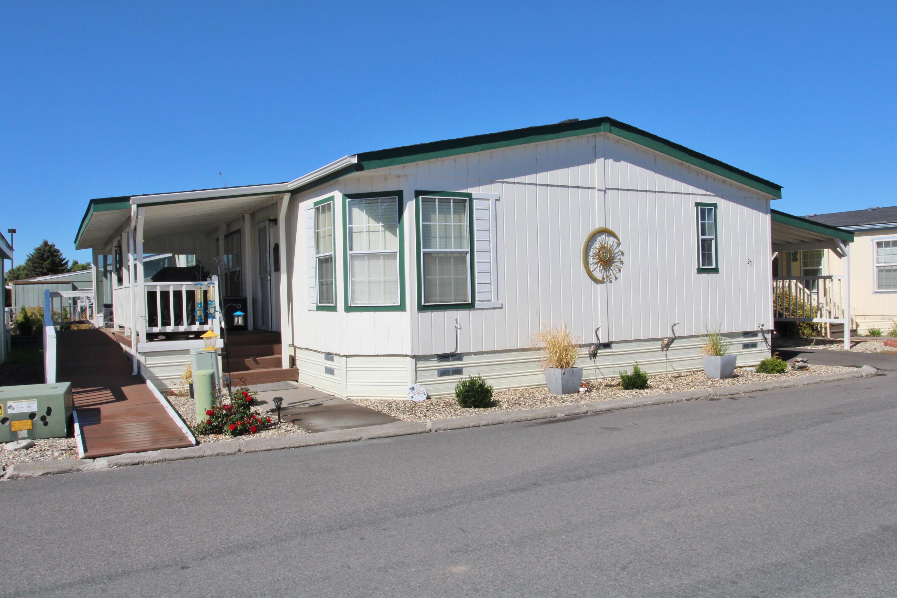 Super in Alpine Meadows a 55+ Park with dual decks & access ramp! Perfectly sized 1323 SQFT, 3-bedroom, 2-bathroom home in great condition with 2021 F/A gas furnace, 2020 A/C, newer interior paint, some newer carpet, new rear covered deck allowing for easy dog door/pet access to yard & more. Large great room with dining kitchen combination, including all appliances, gas range & washer/dryer too. Large primary bedroom with walk-in closet, soaking tub & a convenient walk-in shower in the guest bath. Large covered south facing front deck with handy-cap accessible ramp, fenced yard with planter beds, covered carport & handy storage building & close to the front of park & mailboxes. Current Park rent of $426 month includes water, sewer, garbage & snow removal & use of pet park. Club House, RV storage area & RV rental spaces too for additional fee. See Park Manager at space #1 for park approval. Easy to show so call today!