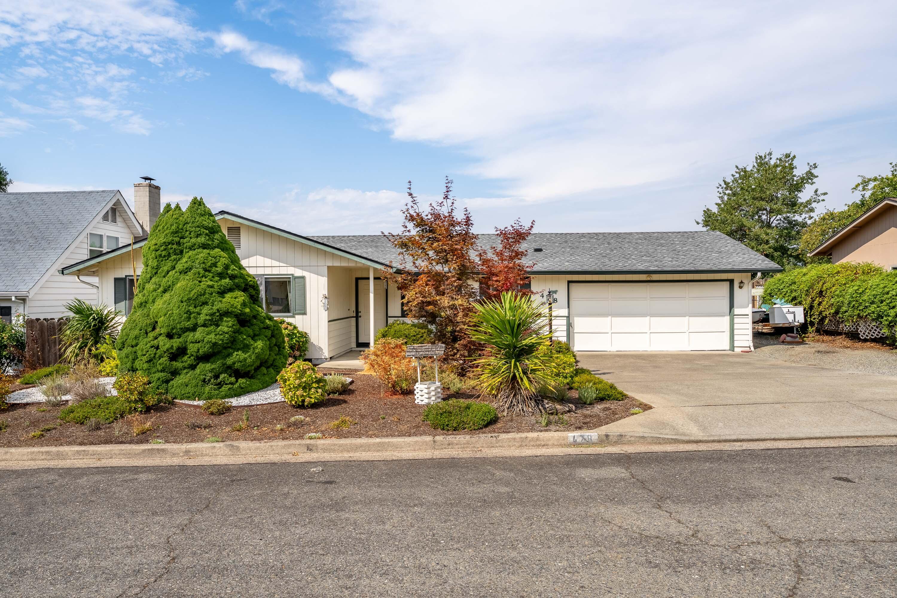 Charming 3-bedroom, 2-bath home with 1,214 sq ft on a spacious 0.22-acre lot in Northeast Grants Pass. This convenient location offers quick access to shopping, schools, and I-5, making it ideal for commuters and families alike. The single-level layout includes a comfortable living area, tile flooring in the kitchen and dining, and an attached 2-car garage. While some features, including carpet and HVAC, are dated, the home has been well cared. The fenced backyard includes sprinklers and room to create your own outdoor retreat, with neighborhood and mountain views nearby. A true diamond in the rough, this property is financeable and well-suited for first-time buyers, downsizers, or investors looking for value in a desirable area of Grants Pass.