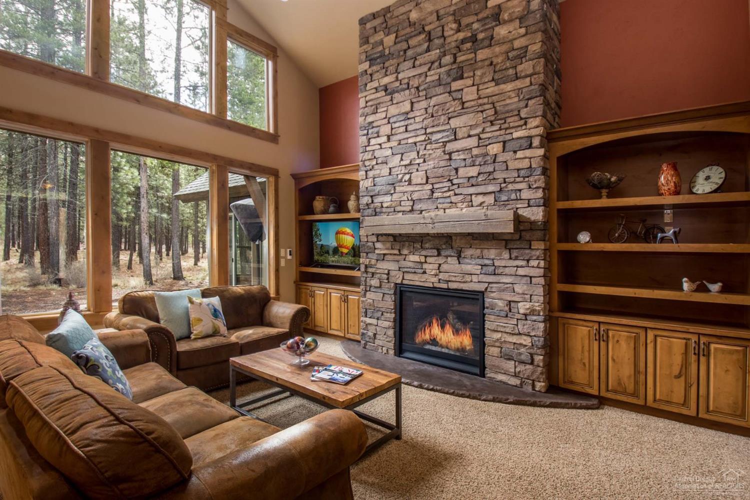 A timeless design! Nestled among majestic pine trees this nearly 1/2 acre (.41) lot, quality, hand-crafted home has everything you're looking for. Including a beautiful kitchen, hand troweled walls, hardwood floors, a master suite with a spa-like bath, additional 2 bedrooms with attached bathrooms, den, bonus room, hot tub, plus an oversized garage. There's room for everyone. Just off the eating area enjoy the peacefulness of the forest. The large backyard adjoins the common area with paved walking paths.