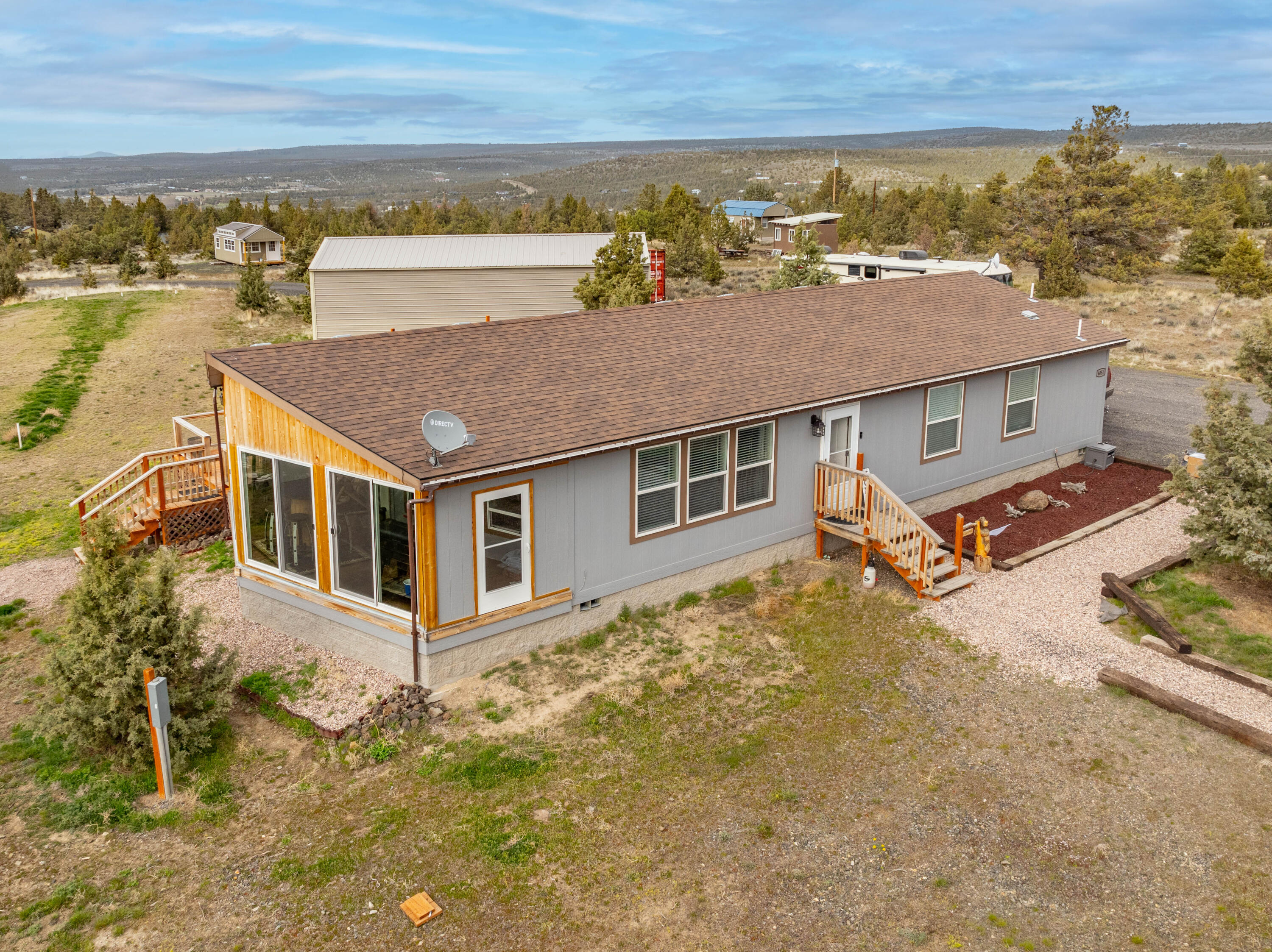Located 9 miles from Prineville Reservoir, 12 miles to Prineville in fast growing Crook County. Property is adjacent to 40 acres of BLM. West end of home has an enclosed porch with multiple picture windows showcasing the expansive views of Sisters, Smith Rock and Mt. Hood as well as neighboring buttes. Road frontage has privacy fence and 2 gates. 30 amp RV hookup and 50 & 100 amp service, 20'x40' carport with concrete floor. 20'x35' second carport. Insulated and heated pump house. 3 conex boxes for plenty of storage. Conex Box with electric and water spigot at animal stall. Large fenced arena for horses.  Home has Smart stainless steel dishwasher and glass top/convection optional range. Fridge is stainless steel. Farmhouse Style deep stainless steel sink. Tile backsplash and stainless steel range hood. Trane heat/ac system. Electric Shades on windows. All new LVP flooring.