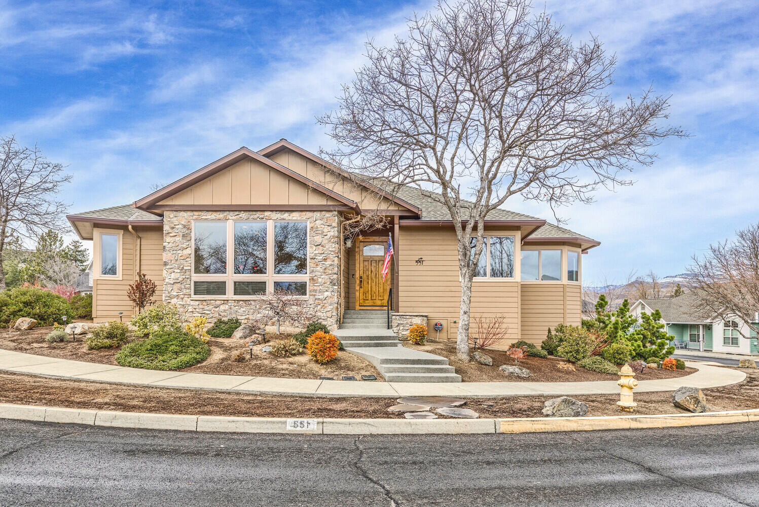 Impeccably maintained, single-level home with high-end finishes throughout on a corner lot with mountain views. This Asher built home will not disappoint with beautiful walnut floors that grace the open floor plan. With high ceilings and a stone surround gas fireplace, the great room is a wonderful gathering place. A large central island topped with granite ties the living area to the chef's kitchen with custom cabinets, stainless steel appliances and ample storage. A dining area opens to the covered back deck, creating the perfect indoor/outdoor living scenario. There are two primary bedrooms. The main one opens to the back deck and has a large walk-in closet and ensuite bathroom with a soaking tub and custom tiled shower. The second primary is on the opposite end of the home allowing for privacy and separation of space. The oversized garage has shop space and connects to the house through a lovely mudroom/laundry room. This is like moving into a new home and will satisfy any buyer.