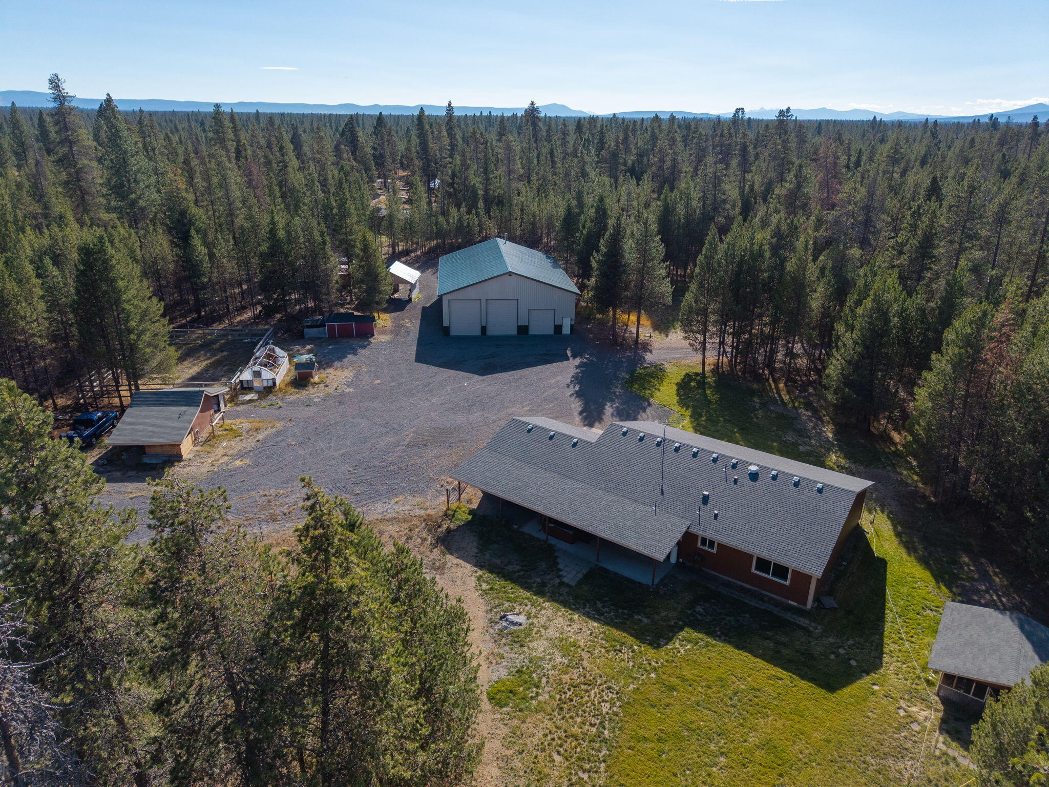 Discover exceptional privacy on 16 forested acres, surrounded by nature and bordering public land for endless recreation. This La Pine property features a comfortable 3 bed, 2 bath home with new LVP flooring, new interior paint, and peaceful views in every direction. A standout 3,600 sq ft heated workshop provides substantial space for equipment, vehicles, and projects. Additional improvements include a 2024 rider's cabin, a 2,500-gallon underground water tank, and a chicken coop with poultry house. The land offers dry-pasture areas, gently rolling forest, and ample room for animals, storage, and future expansion. A private commercial fire truck is also included with the property. A striking blend of generous space, exceptional functionality, and captivating forest scenery.