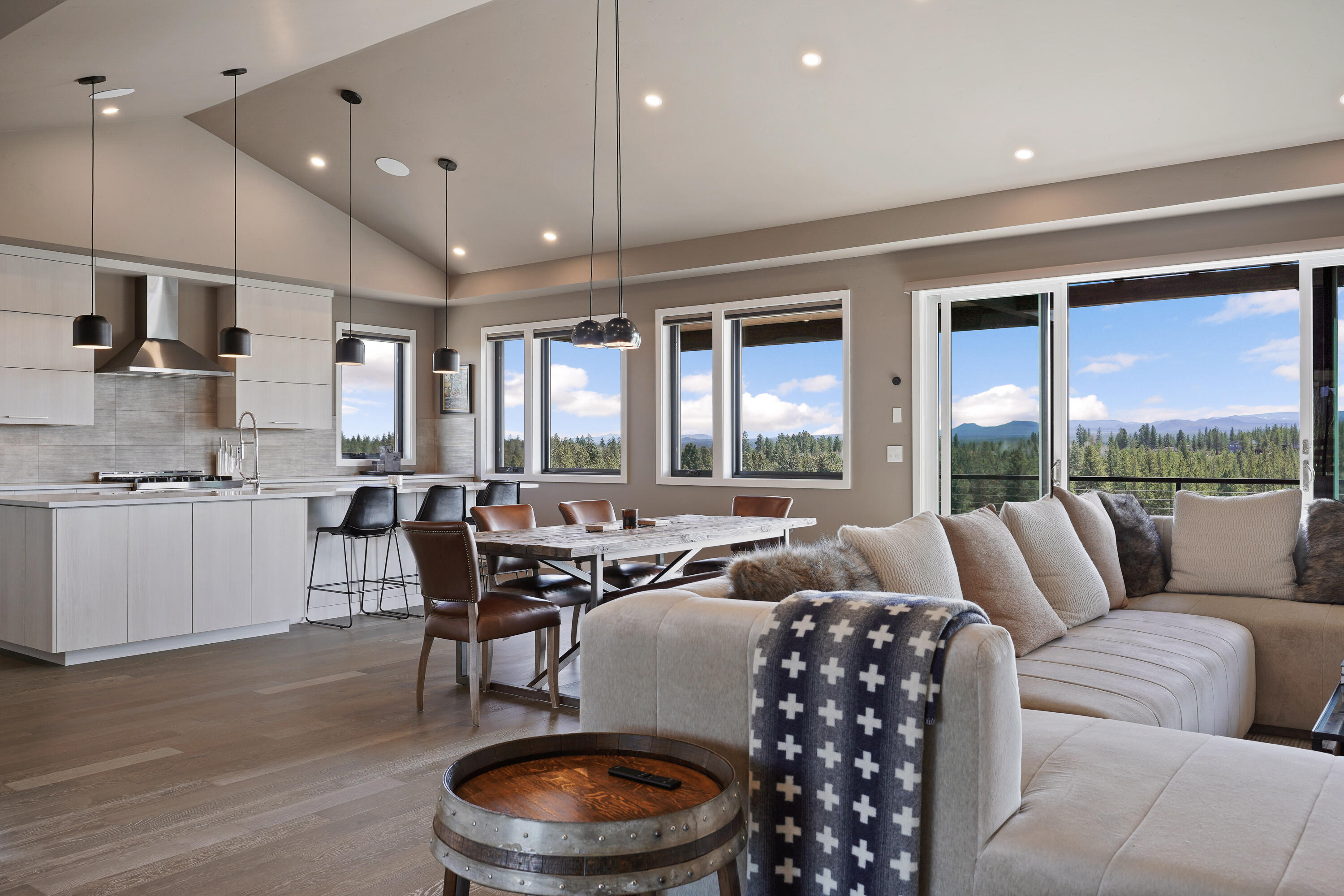 Discover this beautiful single-story home in the sought-after Trailhead neighborhood of Tetherow, perfect for those seeking easy lock-and-leave living. Enjoy expansive butte views from this BendTrend-built gem, featuring 4 bedrooms plus an office, a spacious mud/laundry room, and an open vaulted floor plan designed for effortless living. Located across from the Tetherow clubhouse and pool, this home offers luxury finishes including quartz surfaces, wood and tile floors, fully-tiled showers, radiant floor heating, custom closets, Jenn-Air Pro appliances, AC, and a Sonos system. The private walk-out deck is ideal for watching Bend's stunning weather patterns. With a spacious 2-car garage and direct access to the neighborhood trailhead, this home is just minutes from Mount Bachelor's skiing and outdoor activities. A perfect blend of luxury, comfort, and convenience!