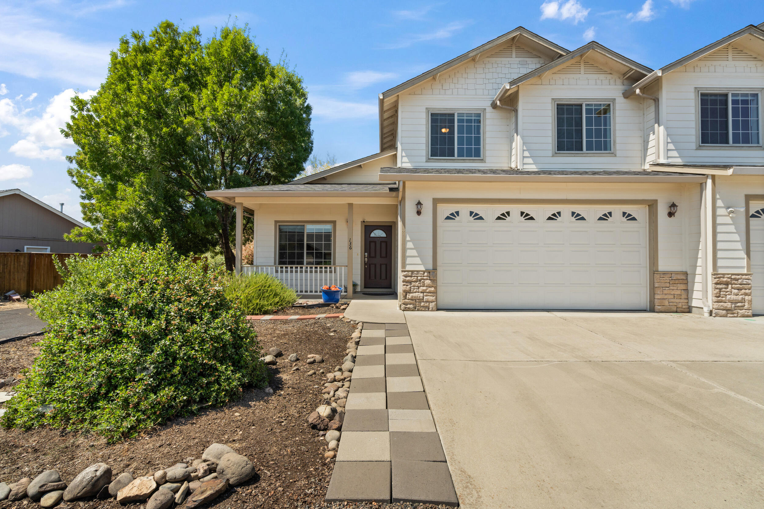 This house comes with a REDUCED RATE as low as 5.875% (APR 6.114%) as of 08/26/2025 through List & Lock™.  This inviting 3-bedroom, 2.5-bathroom townhome offers a well-designed layout with  open-concept living and dining areas that flow seamlessly into a kitchen equipped with modern appliances. The main-floor primary suite features a walk-in closet and a double-sink vanity. Upstairs, two bedrooms share a full bathroom and a versatile landing space. The covered backyard patio provides a serene setting to enjoy the surrounding views. Located near Eagle Point High School, this home combines functionality with a prime location. The downstairs LVP flooring is brand new giving a fresh feel upon entering the space. Explore the opportunity to purchase 130 Dianne Way alongside this unit, offering a unique multifamily living or investment option. NEW ROOF and AC unit in 2022!