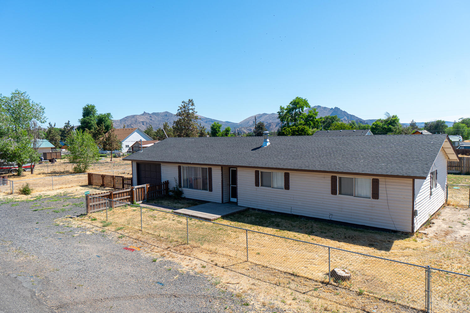 Live and play in the heart of Central Oregon. Less than a ten minute drive to Smith Rock State Park, just off HWY 97 sits this 1,342 sf move-in ready home w/ views of the mountains and Smith Rock. Laminate flooring throughout, the main living area features a tiled surround pellet stove for heating. Heading through the dining area you'll find double doors that lead out back as well as the kitchen area which features plenty of natural light. Home features four carpeted bedrooms and two full baths. Fully fenced yard is perfect for pets! RV parking area and plenty of room in the yard for entertaining year round! Don't miss this chance to live in the heart of Terrebonne!