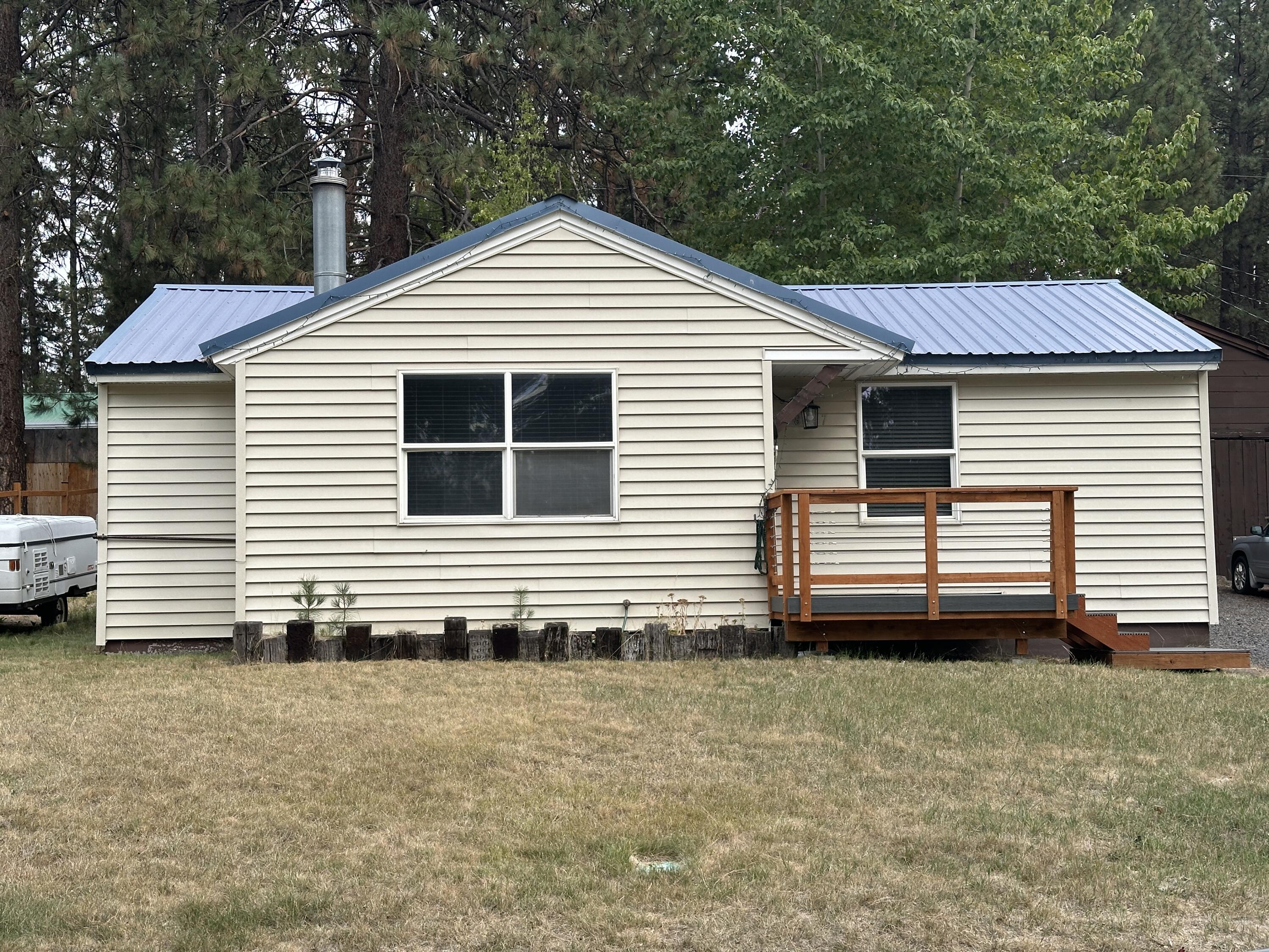 Vintage Bungalow in Gilchrist Townsite-Home has been tastefully updated along with the shiplap that remains to give extra character to this vintage home. 2 bedroom/1 bath along with an office- mudroom-what ever your needs are for that additional space! Home offers SS appliances and washer /dryer for the new owner. Cute house that you could be calling home!  Backyard fence has been started by the neighbor-front porch is an updated TREX decking and railing-check out the updates in the home-updated bathroom with tile shower, new vanity, lighting, flooring, and new solid doors on bathroom and bedrooms-flooring is updated-kitchen boasts the newer cabinets and counter tops along with the same amazing tile back splash-now for the back porch which is a great space to hang out with company and enjoy the weather-the back yard needs your green thumb touch and make this back yard an oasis!-Garage is shared as is most of the garages in Gilchrist  Call your favorite realtor to schedule a showing!