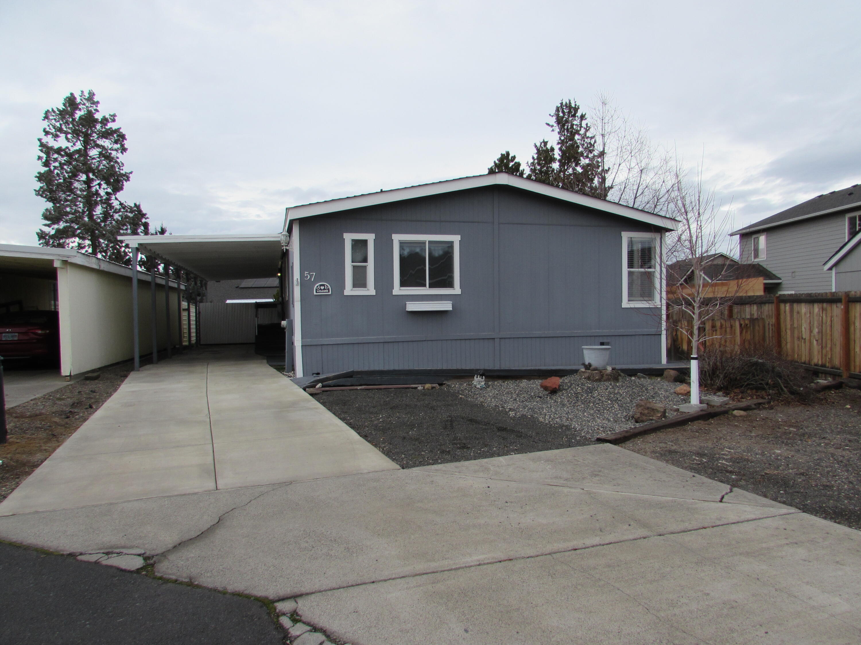 Large double wide mobile home with privacy on a corner lot and long covered driveway with handicap ramp access. Home is 3 bedroom and 2 full bathrooms with large master suite. There is a nice wrap around deck and large storage shed in back. A fairly new 2019 Trane Heat Pump will keep the home cozy this winter. Exterior paint looks great and interior is in good shape but needs a little TLC.
Home is priced to sell.