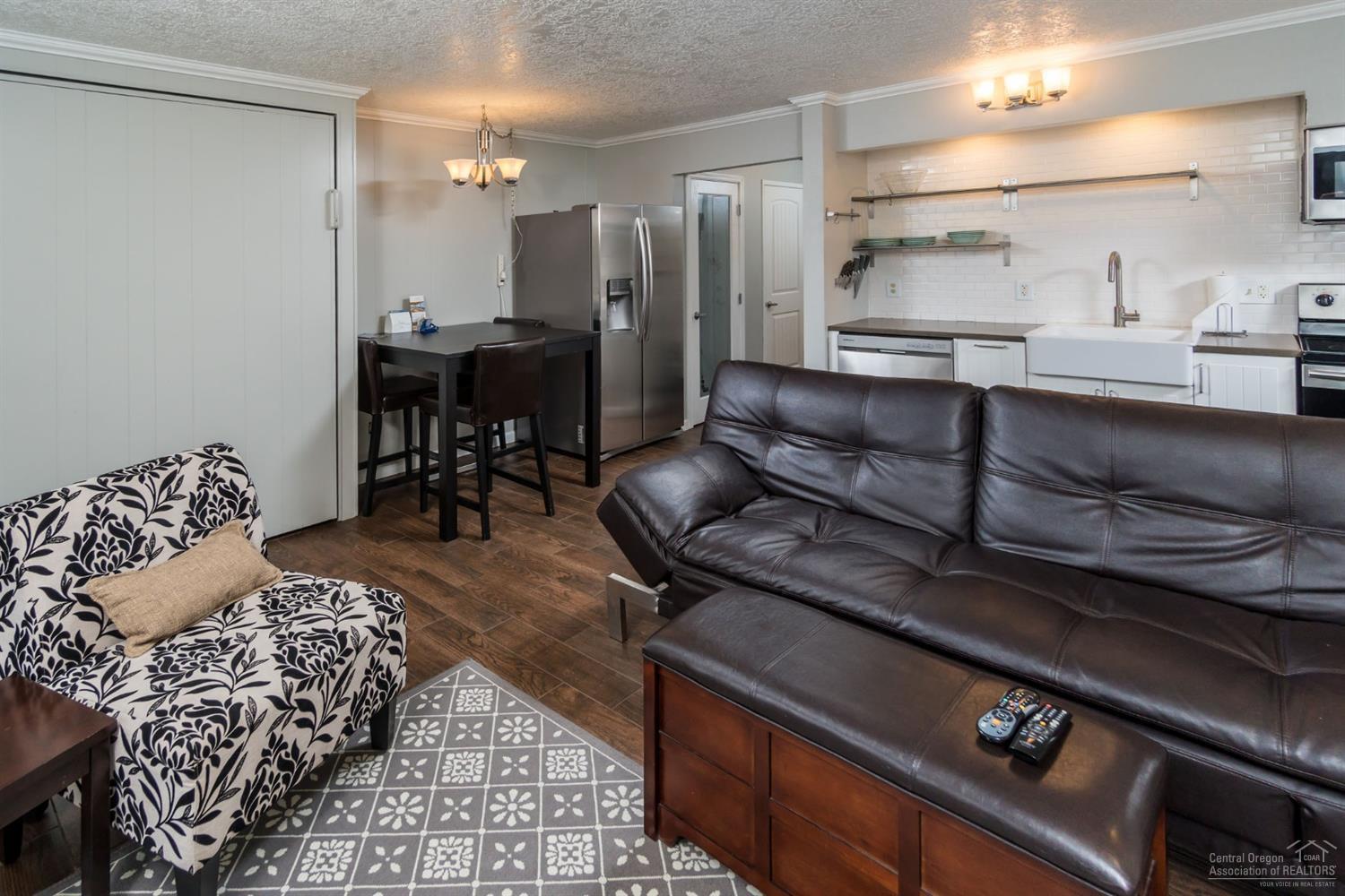Turn key condo close to Downtown Bend and steps to the Deschutes river! Located right next to Pioneer Park, this second floor condo is perfect for your Bend getaway, income producing property or home sweet home! This condo has been used most recently as a vacation rental and had an extensive remodel with high quality finishes. There are two full bathrooms as well as two balconies making for nice separation. There is a fold down Murphy bed in the living room for guests. The complex is located less than a mile from Downtown Bend, and adjacent to the Deschutes river trail. HOA dues cover everything!