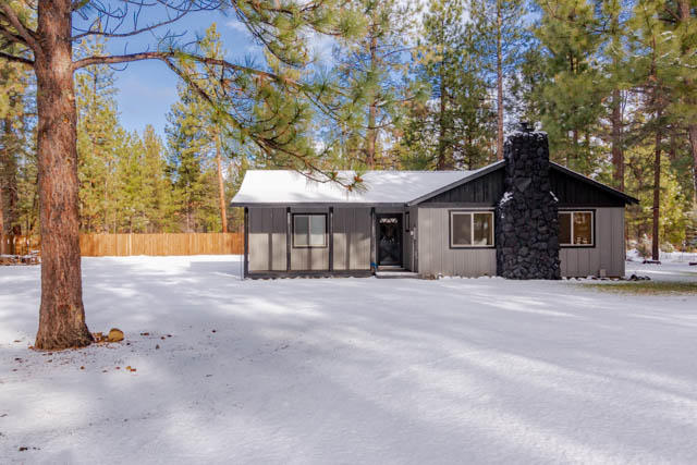 Inside this lovely little beauty is the definition of cozy Americana.  This home exudes ''home sweet home'' appeal with features such as rustic barn doors, exposed beams, black stone fireplace with brand new free standing wood stove, farmhouse sink, butcher block kitchen countertop with mason jar light fixture, tongue and groove wood accent walls, and new low maintenance flooring in the living room and kitchen.  The home sits on a nicely manicured lot and has a new roof, septic, carpet, siding, ductless heat & AC, windows, and new Samsung appliances. Outside, there is plenty of room for parking, and a large stamped rear patio.  Neighborhood amenities include tennis court, basketball court, clubhouse, and pool.  Property backs to national forest land.