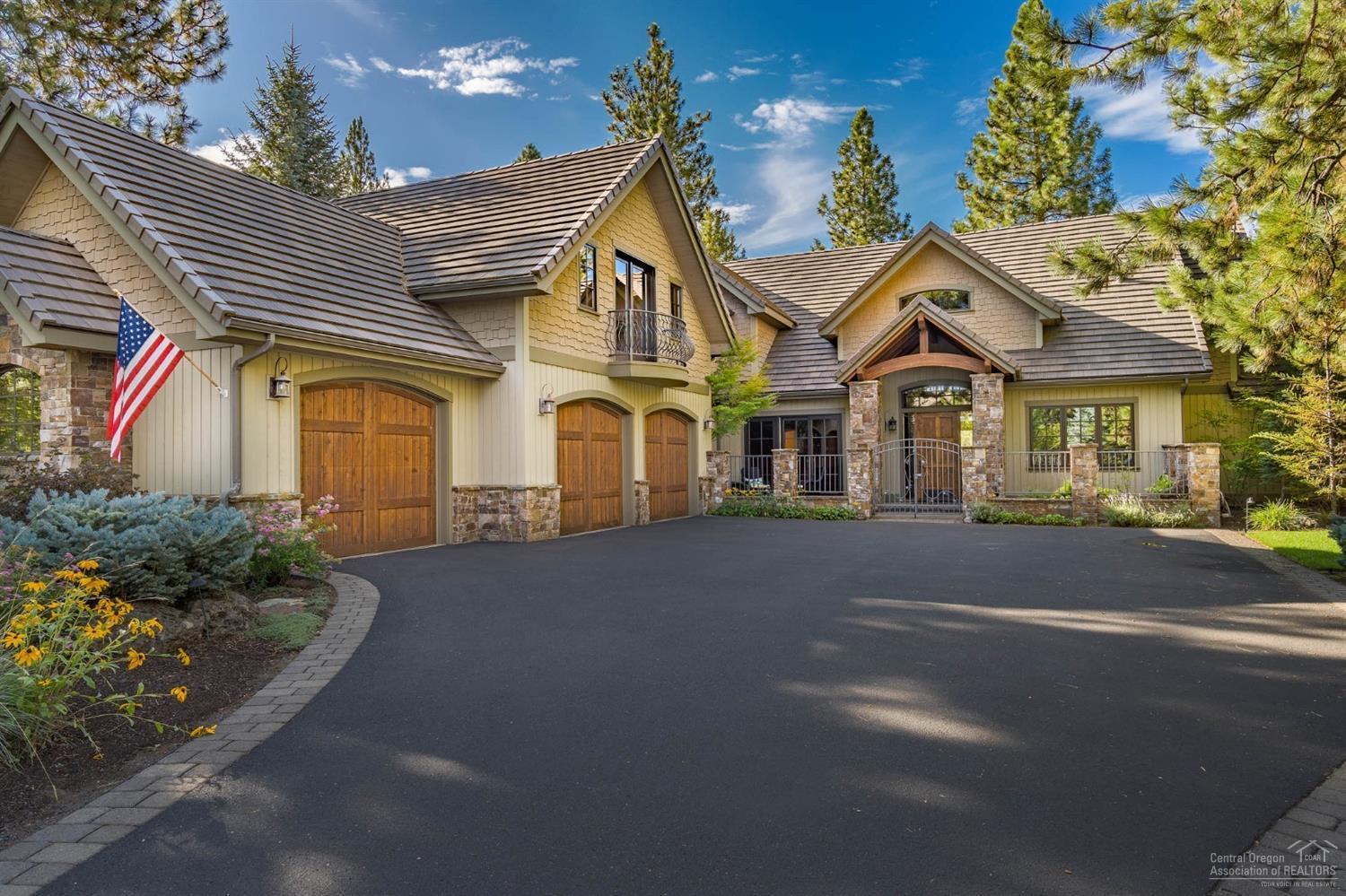 Nestled amongst the pine trees along Broken Top's 7th Fairway, sits this magnificent mountain lodge home. Vaulted & timbered ceilings, wood wrapped windows, massive wood burning fireplace in the great room creates a relaxing space for entertaining or quiet evenings at home. Expansive, golf course view, kitchen includes granite slab island, walk-in pantry, breakfast bar & dining nook with views of back yard landscape. Entertain in style in elegant dining room w/ adjacent wine cellar. Main level master suite offers fireplace, golf course view patio, spacious bath w/ free standing tub, separate vanities, walk-in closet & private patio w/ hot-tub. Wood paneled office is also located on the main level. Home offers plenty of room for family & guests in 2 charming en-suite guest rooms, loft area sitting room & family/media room. Outdoor living area features stone fire-place, built-in BBQ & large paver patio overlooking the golf course, as well as front courtyard w/peaceful water feature.