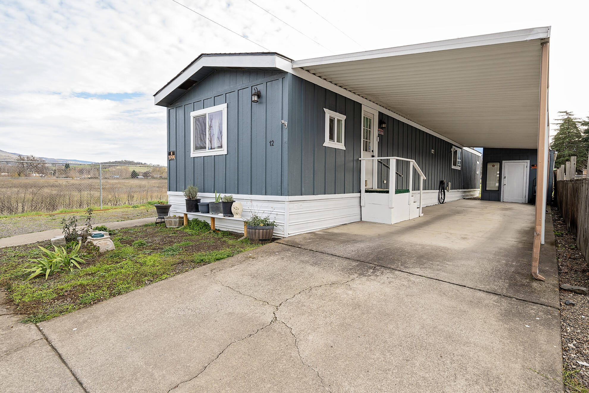 Exceptional value in Greenwood Villiage—offered at a significant discount. This home has been inspected, is vacant, and ready for new owners.

Move-in-ready 3BR/2BA home renovated in 2022, located on a corner lot at the end of the park with peaceful pasture views and Siskiyou Mountain scenery. Updates include an asphalt roof, double-pane windows, fresh flooring, and a stunning floor-to-ceiling tiled primary bath. Open floorplan with built-ins, ceiling fans, and dedicated office space. Heat pump for year-round comfort. Washer, dryer, and refrigerator included.

Enjoy a covered deck and front porch in a spotless, well-maintained community.

55+ park: Owner must be 55+ with application and approval. Approved exceptions allow non-owner residents under 55.

Affordable $578/month lot rent. Convenient to Phoenix, Ashland, and Medford. Clean, inspected, and priced for buyers looking for a deal.