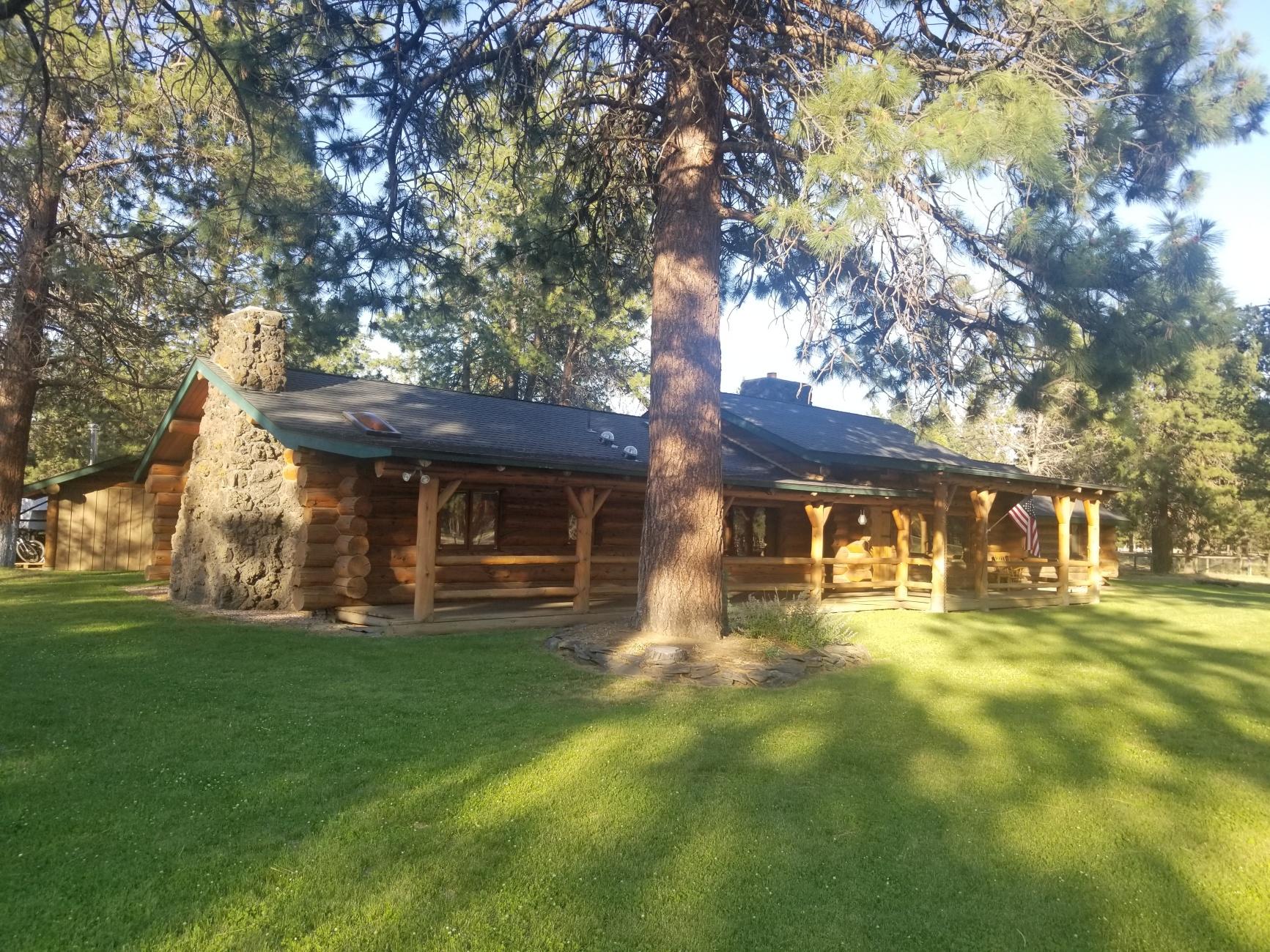 Horse property in Sisters, Oregon. Beautiful single story log home, 3 fire places, natural light, 4 bedrooms, 2.5 bathrooms, irrigated lawn front and back. Central AC. Over 5 acres fully fenced, ranch entry with paved driveway and easy turnaround for trailers. Garage/shop and covered car port. Perfect set up for horses: 3 stall barn with tack room and loft storage, 7 total paddocks (2 w/shelters, 2 with stalls), wash area, 2 riding arenas, ½ mile track, extensive R/V and trailer parking. Ride to Nat. Forest trails (apx. 650 yards away)! Large covered front porch, rear deck and a fire pit for entertaining. Ask broker for property info. book. Come live the dream in this rare close to Sisters horse property.