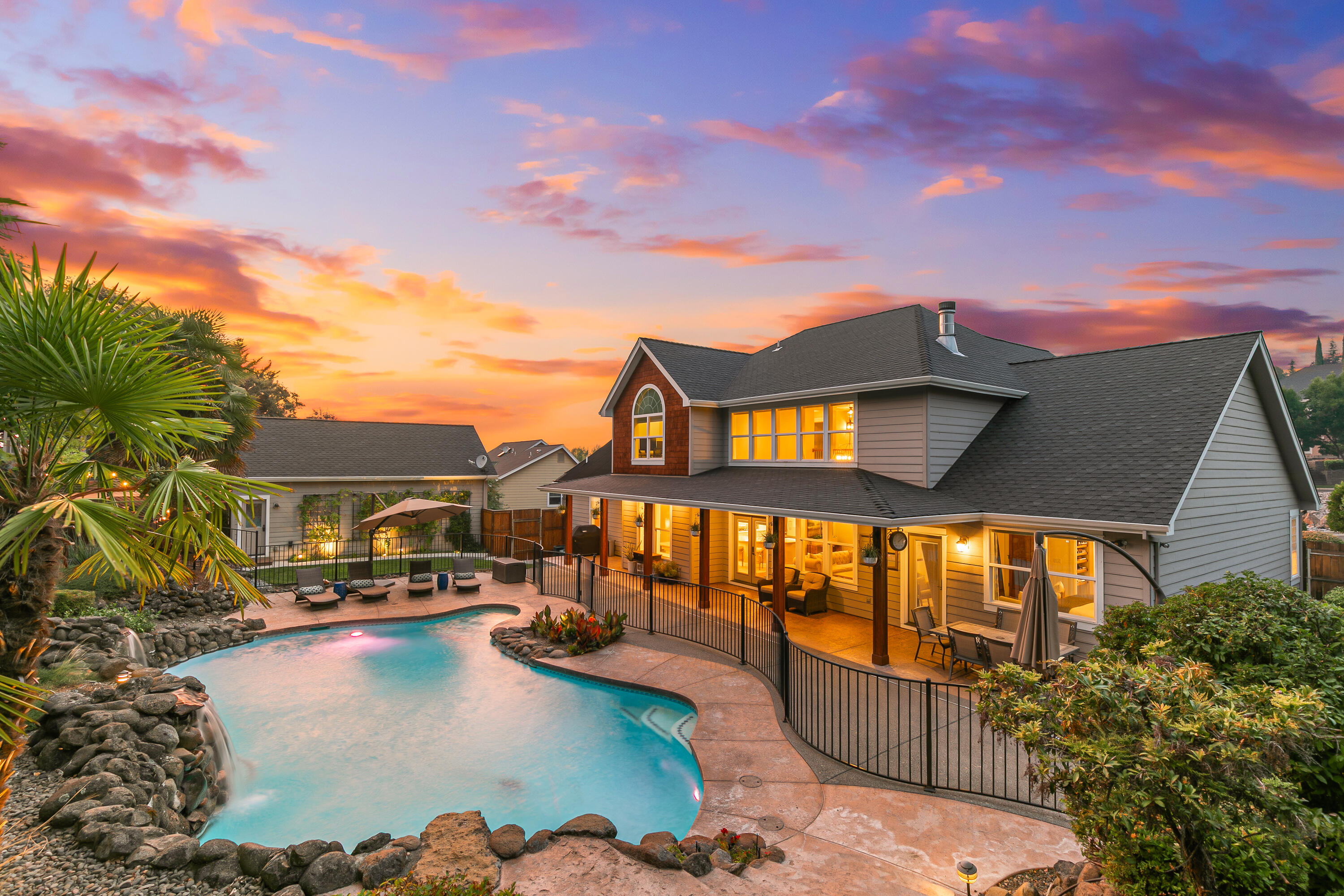 Tucked away on a peaceful East Medford cul-de-sac, this beautifully updated home offers style, comfort, and functionality. Lush landscaping and inviting curb appeal invite you inside, where thoughtful upgrades shine—from the modern kitchen and spa-like primary bath to designer lighting and a custom banquette. The great room impresses with soaring ceilings, a stacked-stone fireplace, and lighted built-ins, while a main-level office with glass pocket doors provides privacy. The 2nd level space features three additional bedrooms and a spacious bonus room. Step outside to your private retreat with mature landscaping, a generous lawn, in-ground pool, and hot tub. A rare highlight is the detached second garage with a fully equipped guest suite above, which includes a kitchenette, full bath, and private deck. Every detail has been carefully curated, making this property a timeless gem in one of East Medford's most sought-after locations.