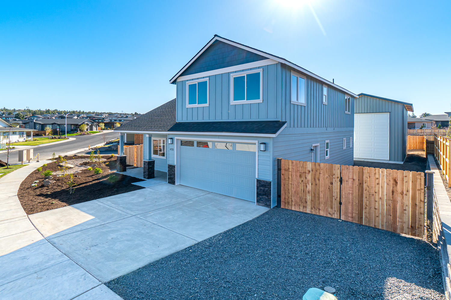 Now complete! Located on the Bend side of Redmond w/Cascade Mtn Views. Spacious living both inside & out, w/plenty of room for entertaining. Don't miss the SHOP - great storage, workshop or flex room! Vaulted Great Room plan w/open Kitchen, tons of cabinetry & prep space on the slab Quartz counters and large island. Neat & tidy full height tiled back splash, SS appliances & farm sink. Living space offers a cozy corner Gas burning fireplace w/stylish accents & room for gathering. Desirable Master on Main level, walk in closet, step in shower, tiled floors & dual vanities. Office/Den downstairs as well. 2 additional guest rooms upstairs w/full bath and large bonus room. Laundry room w/storage & sink. Durable wood look laminate flooring, carpet in the bedrooms/closets & tiled baths. Gas forced air, A/C & back patio. Double car garage, gated RV parking, fully fenced, fully landscaped w/auto sprinklers. 20x30 Shop on the north border, accessible from the street.