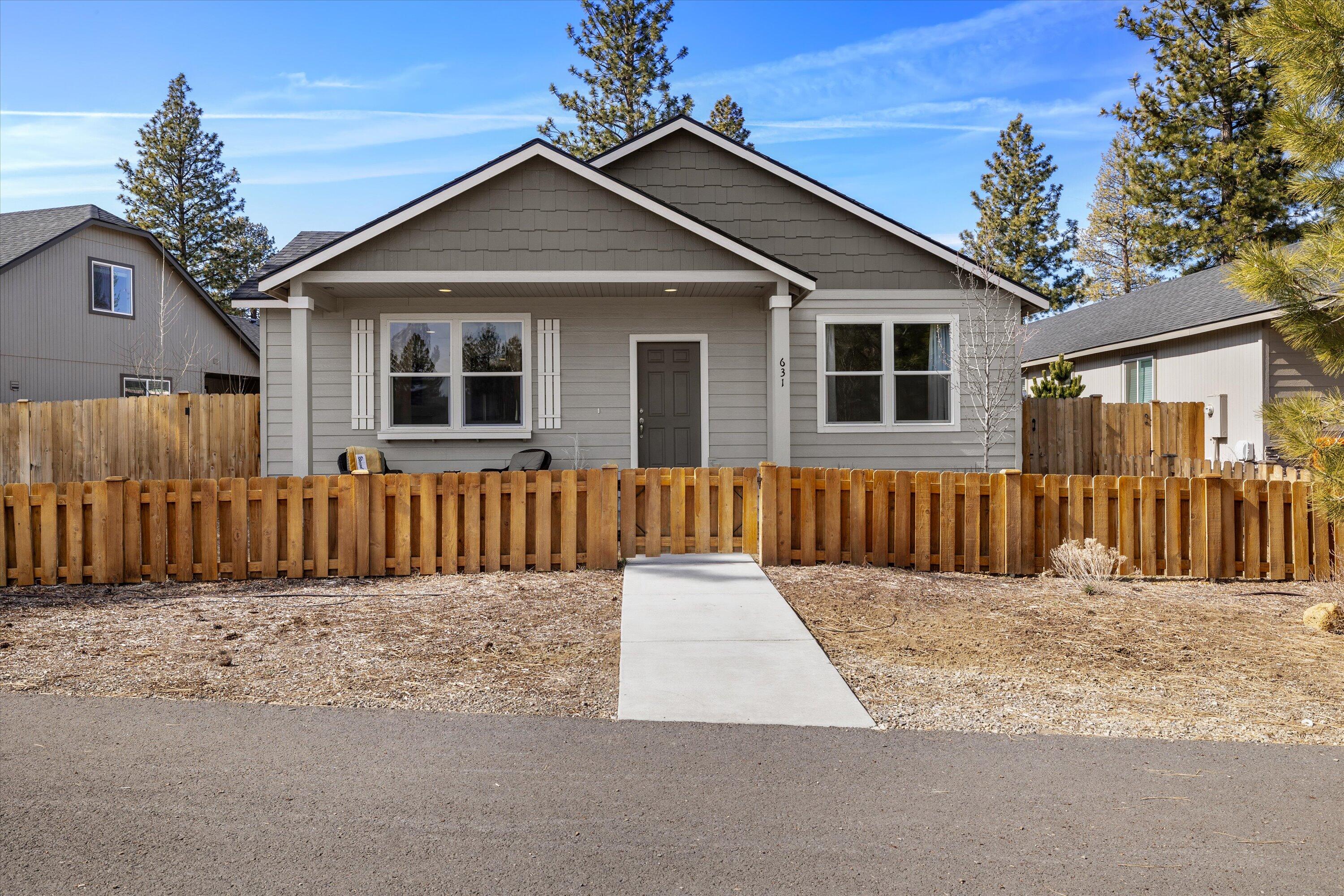 Welcome to this delightful 3-bedroom, 2-bathroom home located in a desirable neighborhood just a short distance from downtown Sisters. Boasting 1,609 square feet of thoughtfully designed living space, this home offers a perfect balance of modern comfort and small-town charm. The spacious open-concept living area is ideal for both entertaining and everyday living, with a cozy fireplace adding warmth and ambiance to the living room. The adjoining dining room and kitchen create a welcoming flow. The expansive primary suite features a large walk-in closet and an en-suite bathroom with a dual vanity, ensuring plenty of space for your personal items and a peaceful retreat at the end of the day. Step outside to your private patio space and enjoy the fully fenced yard—perfect for pets, play, or relaxing in the Oregon sun. The home is located directly across from a lovely community park, adding to the appeal of this location.
