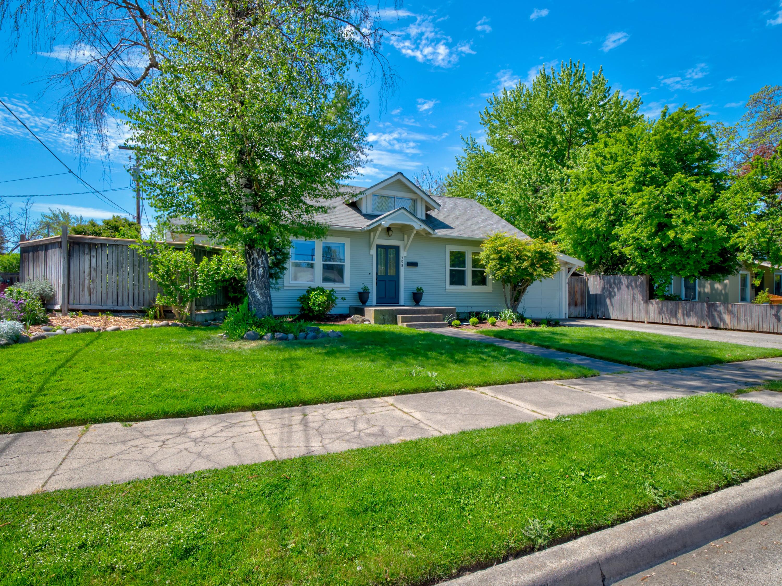 Must See!  Make this home your own! It's a beautifully updated 1930s-built home with 3 bedroom, 2 baths, a stunning entry room with gas fireplace and built-ins, and a dining room with an abundance of natural light. It's the perfect combination of the character you want in an older home, with functional updating already done. New exterior paint, landscaping, bathroom and kitchen updates, and more! This home includes a main floor master bedroom with en-suite bathroom. The fenced backyard includes a back patio shaded by a pergola with mature wisteria, several garden beds, plenty of room for a play-set or pool, and a shed with heat and electricity (perfect for your very own she-shed, or man-cave).