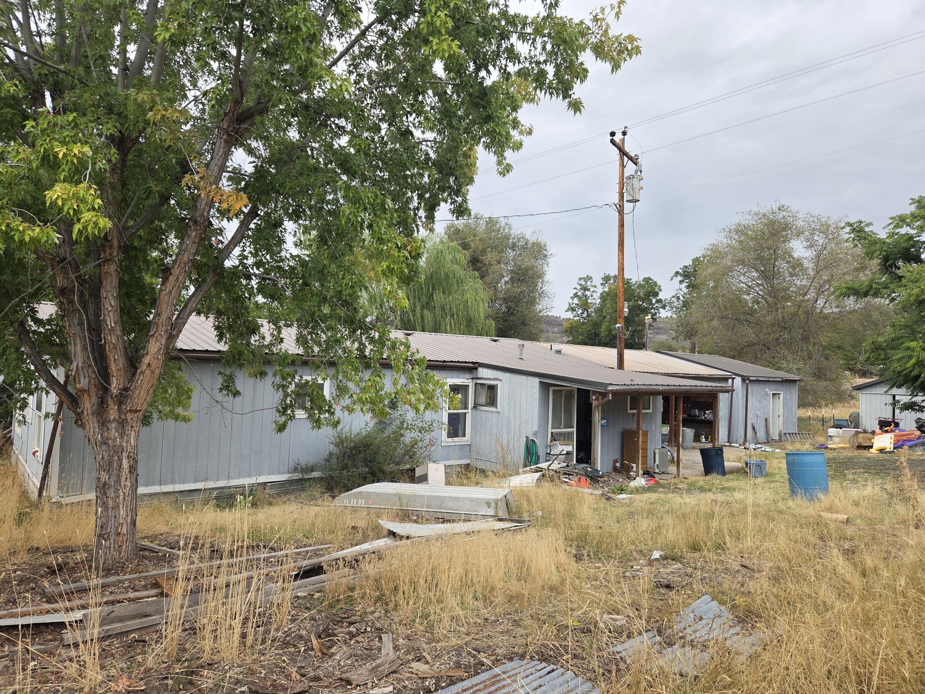 A home that needs some love and care located in remote Spray. This 3 bed 2 bath manufactured home could be a wonderful home or small town get away. Right now it is offered as is. The over .57 acre lot, multiple out buildings, and quiet street make it appealing, but it is not for the faint of heart, it is a project with clean up inside and out. If you have the vision, this one could be for you.