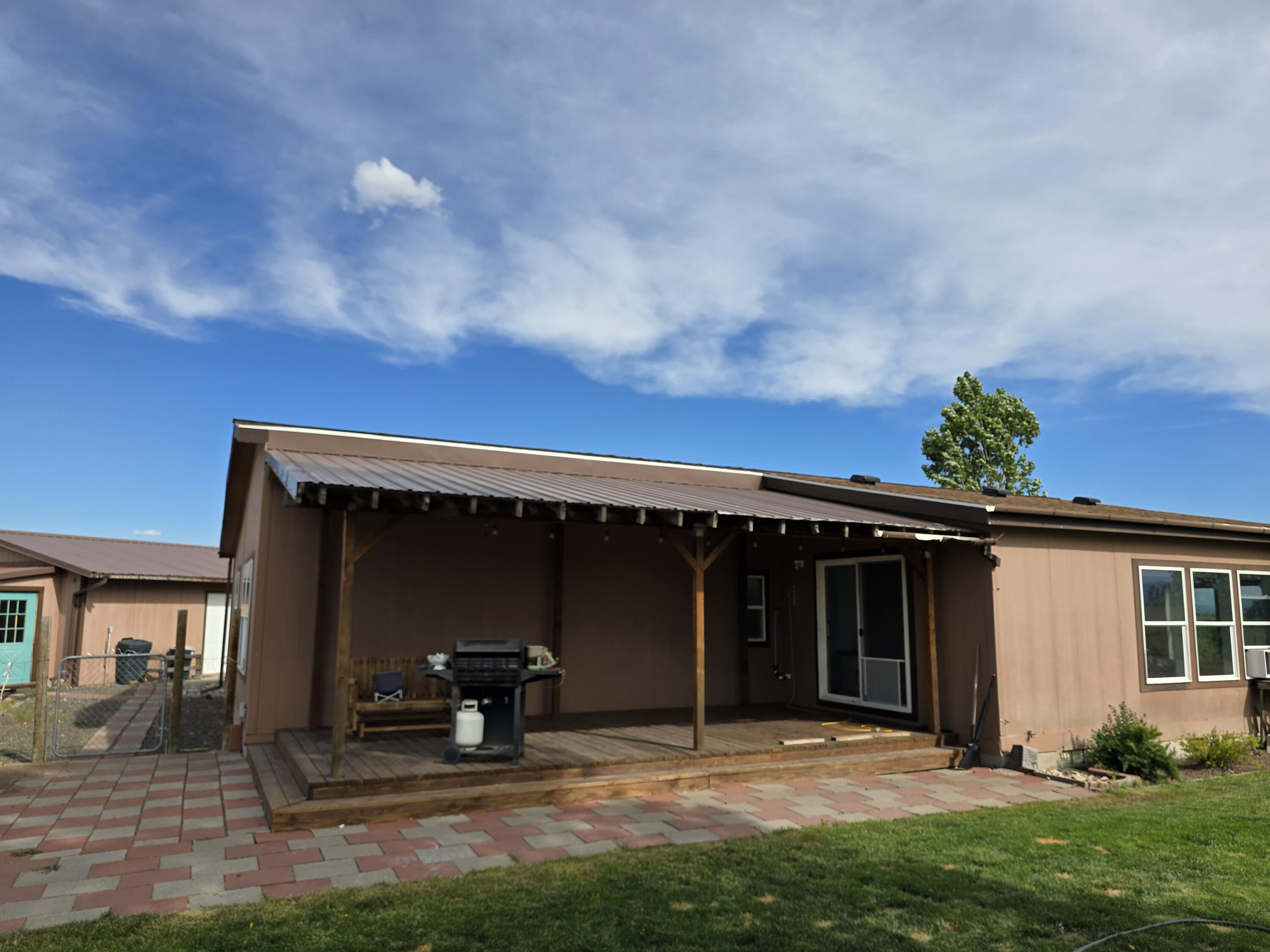 Located minutes from Lakeview, this well-kept 3-bedroom, 2-bath manufactured home offers a quiet, functional setup with wide-open views of the high desert and the Warner Mountains beyond. The house sits on 11.44 usable acres-ideal for livestock, 4-H projects, or a modest hobby farm. The home features an open-concept kitchen and living space with vaulted ceilings and an abundance of natural light. The primary bedroom features its own space to grow, room to roam, or a serene en-suite bath, and the mud/laundry room provides convenient access from the back entrance-ideal for rural living. Outside, there's a detached two-car garage, multiple outbuildings, and a mix of lawn and pasture already fenced. With mature trees, a reliable well, and year-round accessibility, this property is well-suited for buyers looking for space to grow, room to roam, or a simple retreat from town. No HOA, no nonsense-just clean country living in Oregon's Outback.