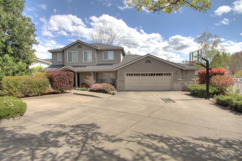 This is the first time on the market for this super nice custom built home in the sought-after Lone Pine School District. The well thought out design has been graced w/a large, updated island kitchen w/slab granite counters, abundance of cabinets, & built-in buffet. There's a family room & breakfast area w/French doors to the patio. There's also a formal dining room & living rm w/ fireplace, built-in shelving, & French doors to the patio. A huge benefit is the handicapped suite at one end of the home! This features a large private living space, bathrm w/roll-in shower, walk-in closet, & French door to the patio. Plus, there is a bedrm & full bath across the hall. This can all be accessed either by a separate outside entrance, or a hallway to the kitchen. The additional bedrms, bathrm, & master suite are located on the upper level of the home. The 3342 sq ft home sits on a street with other beautiful homes, and has a huge driveway w/extra parking, & oversized garage w/shop area.