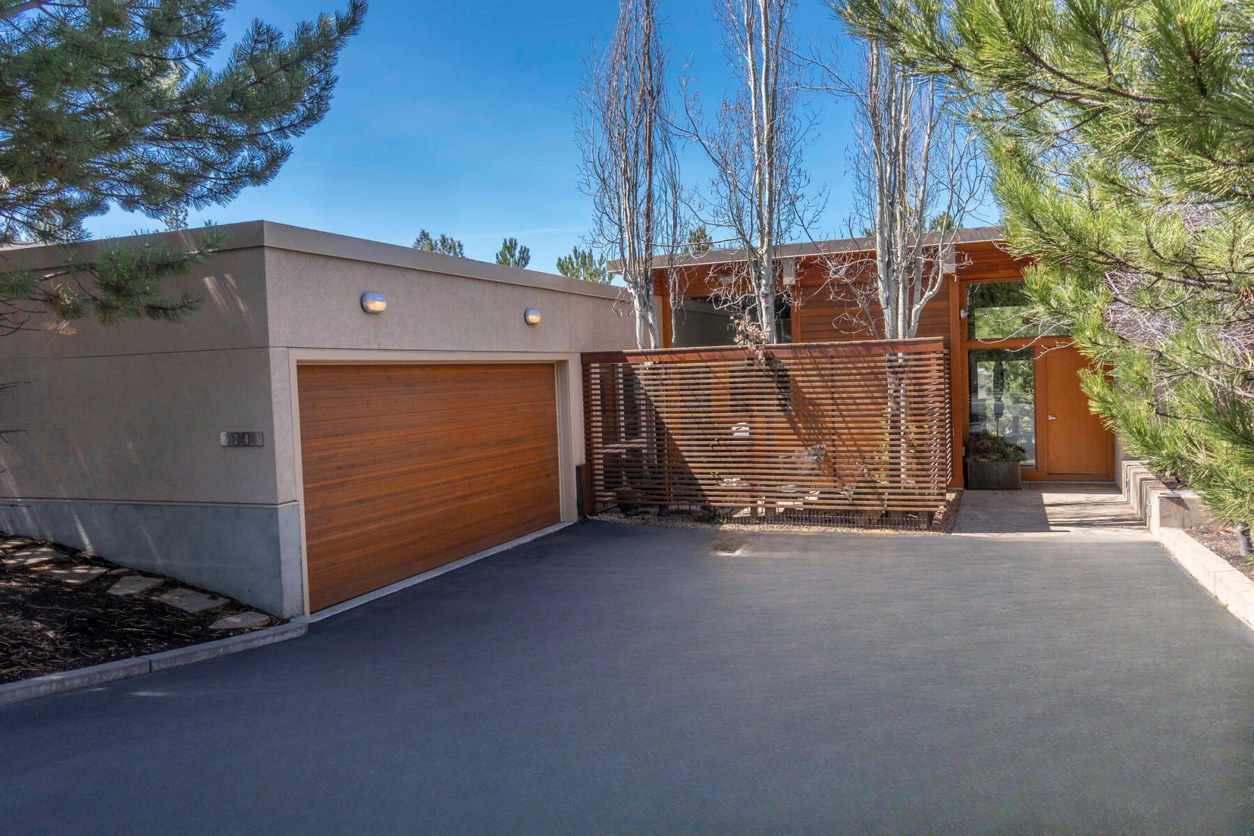 The Art of Living Well! Masterfully updated modern architecture showpiece with stunning detail at every turn in the desirable Shevlin Reserve community featuring partial Cascade Mountain views. Offering one en suite and one large guest bedroom, office alcove, 2.5 baths, 1,800 square feet of single level living space, and 2-car garage, this renovated contemporary design composes a private enclave of natural light, comfort, and harmony with the surroundings. An impressive 23-foot wall of sliding windows, white oak hardwoods, concrete flooring with radiant heating, wool carpeting, exposed beams, tongue and groove ceilings, stainless steel appliances, and 2-gas fireplaces elevate this timeless space. The home beautifully encompasses the patio and courtyard creating connectivity on all sides and a seamless transition between inside and out. Celebrate the Bend lifestyle with Northwest Crossing, Discovery and Shevlin parks, and unlimited hiking and biking just beyond your door. Welcome home!