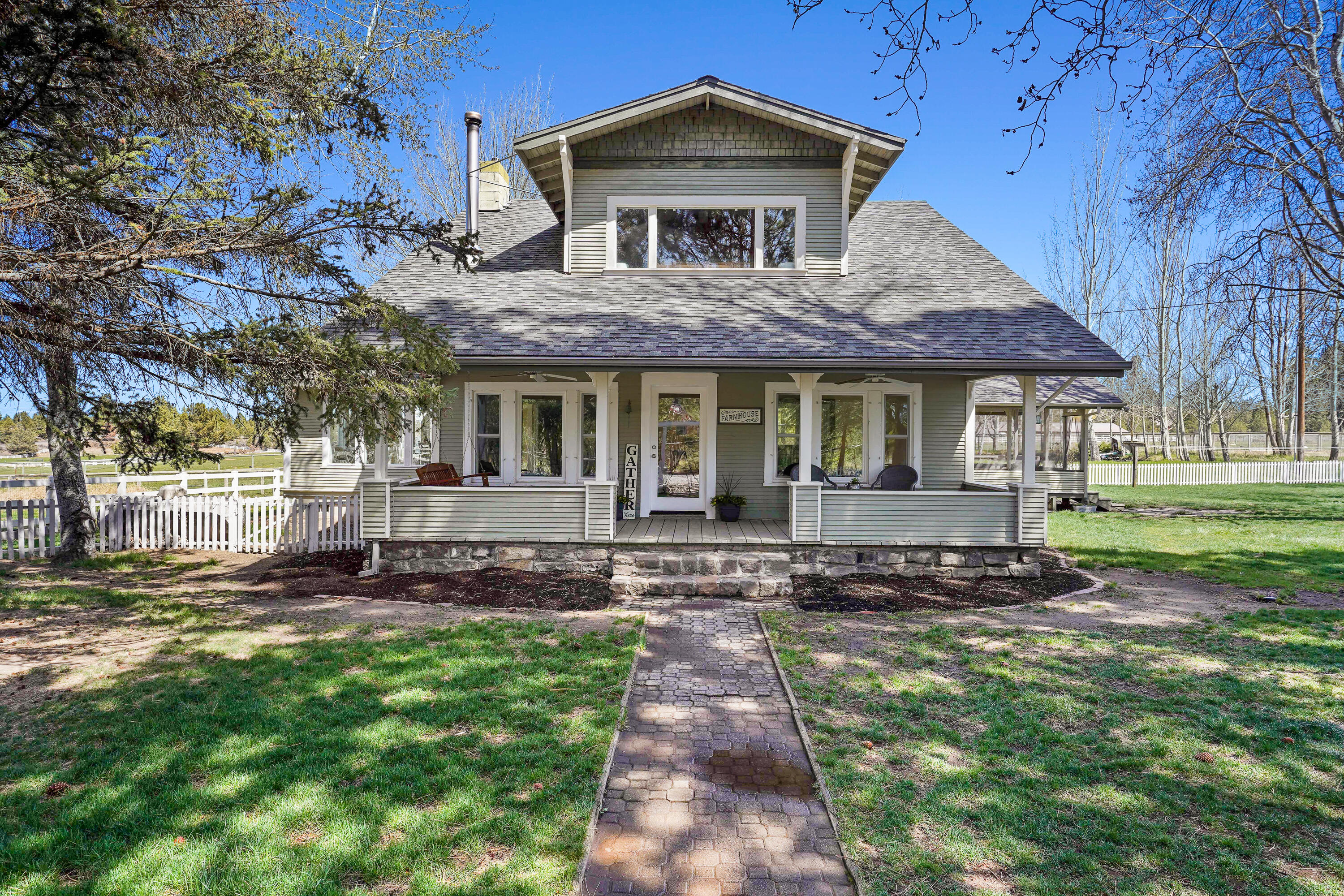 Welcome to this historic 1920's farmhouse, located in SE Bend. This beautifully restored home is 2-story, 3808 sq. ft. and includes a full basement & living quarters with it's own private entrance. The wonderful home has upgrades throughout including a new wood stove, new pellet stove, new windows/doors, new septic but still maintains the charm of old with big living spaces and plenty of room for entertaining both inside and out. Sit back and enjoy the serene setting on the partially enclosed back porch that overlooks your own private pond and antique greenhouse. This property includes all irrigation equipment on site. 17 acres of the 22 acres has Arnold Irrigation.  And talk about historic charm, you will also find the original potato house plus a 1984 sq. ft., 100 year old barn with original wood planking floor with full loft.