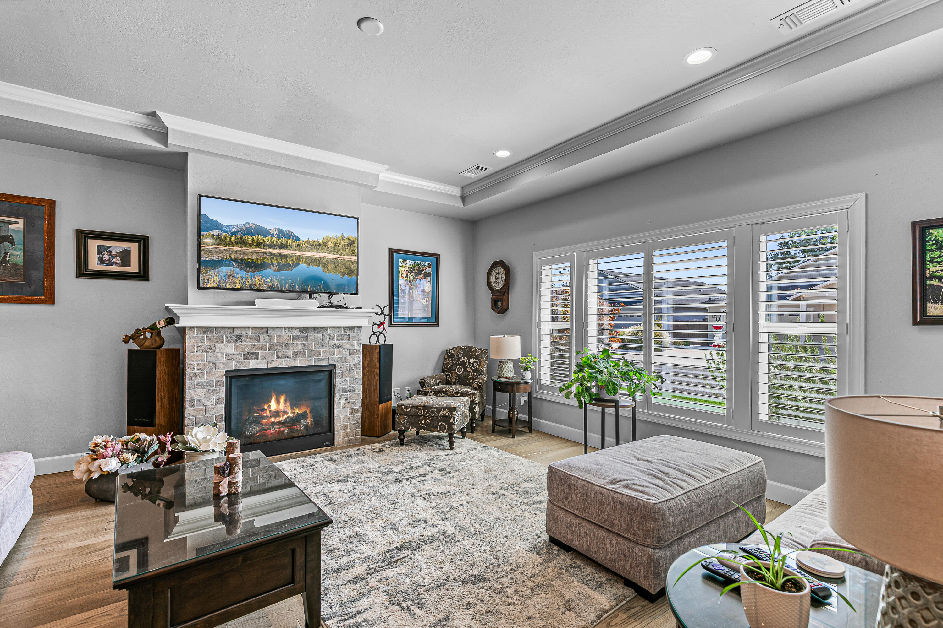 Designed for comfort and convenience, this Snowy Butte Station home features a popular great room floor plan with vaulted/coffered ceilings, hardwood floors in the main living areas, and a cozy gas fireplace. The kitchen shines with granite counters, tile backsplash, stainless steel appliances including a 5-burner range, soft-close cabinetry, and a huge walk-in pantry. The primary suite includes a walk-in closet and dual-sink vanity. Enjoy a covered patio, fenced side yard, and oversized 2-car rear garage with utility sink. HOA maintains front landscaping, with a pocket park just down the street.