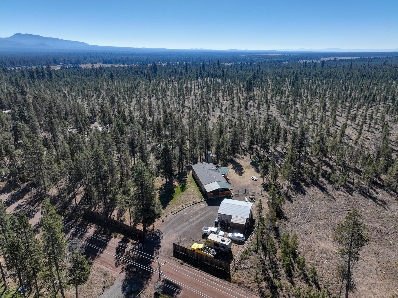 Home & Garage/Shop on 1 Acre Backing Public Lands! 3Bd/2Ba, 1994 built manufactured home on full Block Foundation & FHA/VA tie-downs!  Fully fenced & cross fenced for animals with a front security gate backing to large parcel of BLM land for additional privacy! Open floor plan with master suite & laundry/mud room, covered front & back decks, frame built storage building, chicken coop, large detached 576 sqft insulated garage/shop built in 2000 and a brand new roof in 2021! Close to La Pine State Park & Little Deschutes River!