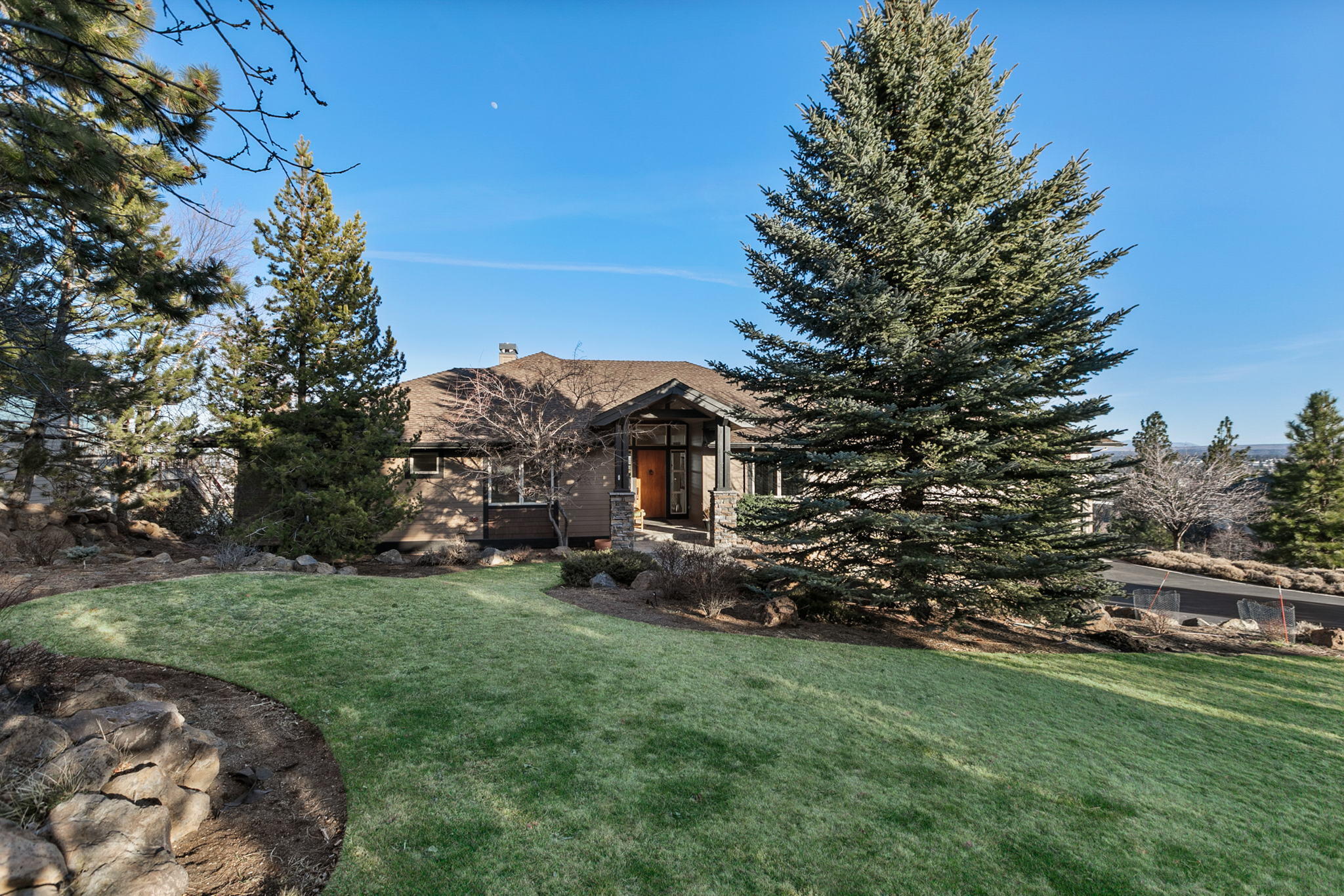 Absolutely Stunning Single level tastefully updated Hillside Park home with an Easterly Panoramic View overlooking the City of Bend, Pilot Butte and situated on a large cul-de-sac lot . This beautifully built home has a open concept floor plan w/great room, stone fireplace, abundance of windows, and opens to a spacious deck. The home was designed by Neil Huston as a mid-century with window framing extending to the floors to add to the open & bright feeling throughout. It has been extensively remodeled thru 2021 with a gourmet kitchen, granite island and counter-tops, upgraded appliances, large pantry and tons of cabinetry. 4 bedrooms (with a lovely private main suite), 4th bedroom can be used as an office, remodeled 3 baths and laundry room (featuring Eco-WD), built-in vacuum system, triple sized garage with additional storage space, and fully landscaped yard with water feature and sprinkler system.  A true gem offering Westside Bend neighborhood and Hillside Park just down the street