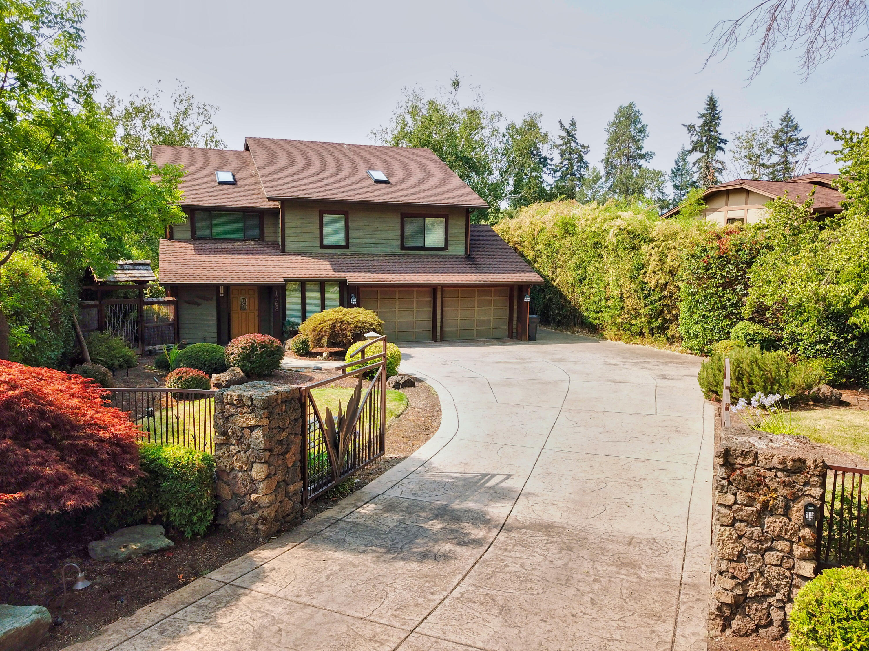 Rogue River waterfront living at its finest. This is what you will find upon entering this lovely home. It doesn't get much sweeter! Enjoy your wall of windows which face your beautiful rolling lawn to the waters edge. This home features creamy Corian counter tops in the kitchen which perfectly compliment the richness of the gorgeous cherry wood floors that flow through out the home. High end window coverings, including custom Shoji screens, provide privacy. The large primary bedroom features an en-suite bathroom with its own gas fireplace and soaking tub over looking the river. On the ground level you will find a 1500 sq ft stamped concrete patio, red cedar ceilings, complete with an in ground fire pit connected to natural gas. Sit in your like new hot tub and bask at the stunning beauty of your river front back yard oasis. Bonus! The custom wine cellar is located close by. The best Grants Pass has to offer on the famous Rogue River is just a phone call away.