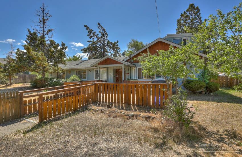 Large Home & Property in NW Bend! Possible development and/or Foster Care Home opportunities with this Half Acre lot in Bend's NW Riverside location! Big 2600sf, 8Bd/4Ba home, 2 master suites, large living room plumed for gas/wood stove with existing beautiful brick hearth, laundry/mud room, office, detached garage + small shop, Hay Barn, Gas FA Heat, plenty of room for ADU addition and RV parking too! Big corner lot(s) with access from both paved roads!