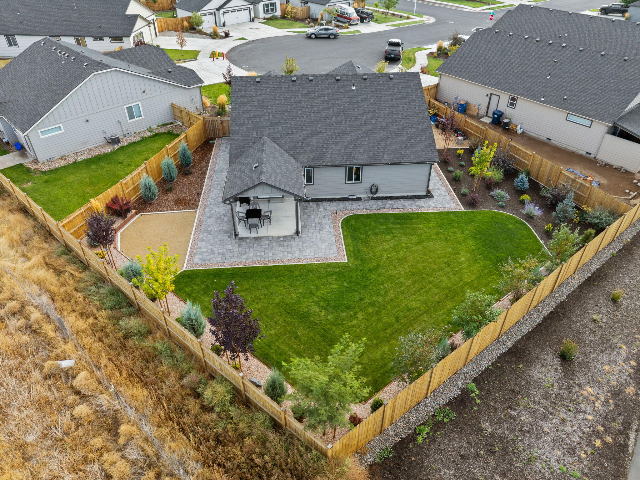 A private oasis on the north edge of Redmond OR ! Built in 2023.  Just blocks from schools and shopping.  Lightly lived in 3 Bedroom, 2 Bath, single level home on large 9,060 square foot cul-de-sac lot.  Beautifully appointed home offering gorgeous quartz countertops throughout,  fantastic open floor plan that includes central AC, vaulted ceilings, custom paint, blinds and more,  The spacious primary suite is thoughtfully separated from the other bedrooms and includes dual vanities, a walk-in shower, and a two generous walk-in closets. Enjoy a fully fenced backyard with a covered patio and beautiful mature landscaping. The spacious 2-car garage features a 4-foot garage extension and built in shelving/workshop. The kitchen boasts of  island with upgrade professional grade stainless appliances and large pantry.  Turn key opportunity as Refrigerator and Washer/Dryer are also included. Your private retreat awaits you!