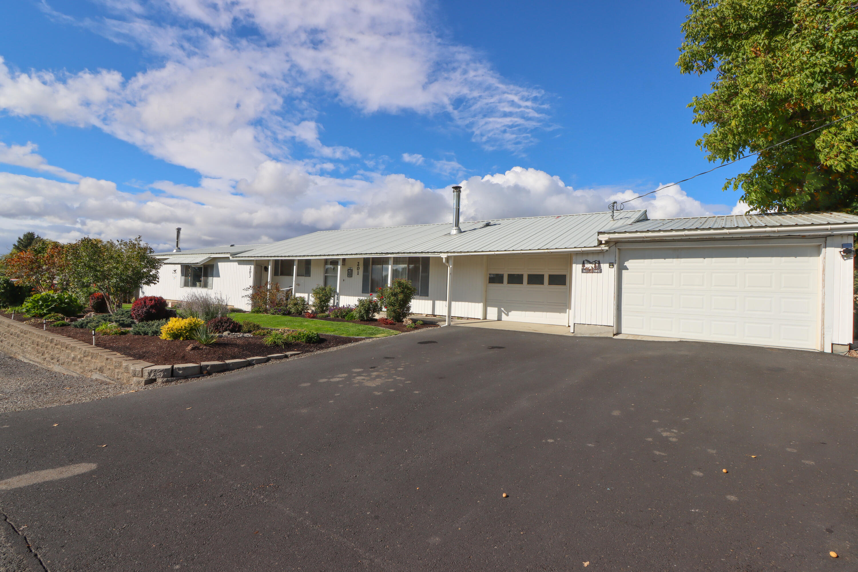 This immaculate duplex on completely manicured lot features a 2 bedroom, office, 1 bath and 1236 sq. ft. on one side and 1 bedroom, 1 bath w/great room design and 870 sq. ft on the other.  Larger unit has extended single car garage w/work area and smaller unit has enclosed sun porch and storage shed.  Both units include washers, dryers, wood stoves and refrigerators.  Both units will be vacated upon closing allowing you to rent units at today's rental rates!  There is also side parking for RV, boat or trailer. This outstanding location is within walking distance to shopping, dining, schools and entertainment.  Nearby Lake Billy Chinook gives you an amazing amount of outdoor recreational opportunities.  Perfect as an investment rental property, multi-generational living, or live in one unit while renting the other.