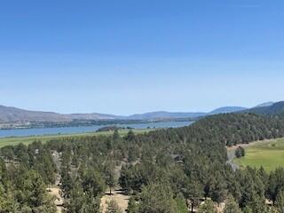 Great lake view without the price!  Enjoy all the Running Y Resort has to offer when you build your home on this beautiful, wooded lot with views of the lake and valley.  Relax on your back deck while observing the abundance of wildlife roaming in your yard and the open space behind.  Running Y HOA amenities include miles of paved walking trails, access to the Sports and Fitness Center (indoor pool, hot tub, sauna, weight room, arcade, etc.) tennis and pickleball courts, basketball, volleyball and a playground for the little ones.  Looking for something more, check out the Arnold Palmer designed golf course or spa.  Enjoy the convenience of having dinner and drinks at the Ruddy Duck or stop into the Market and Deli for last minute shopping.